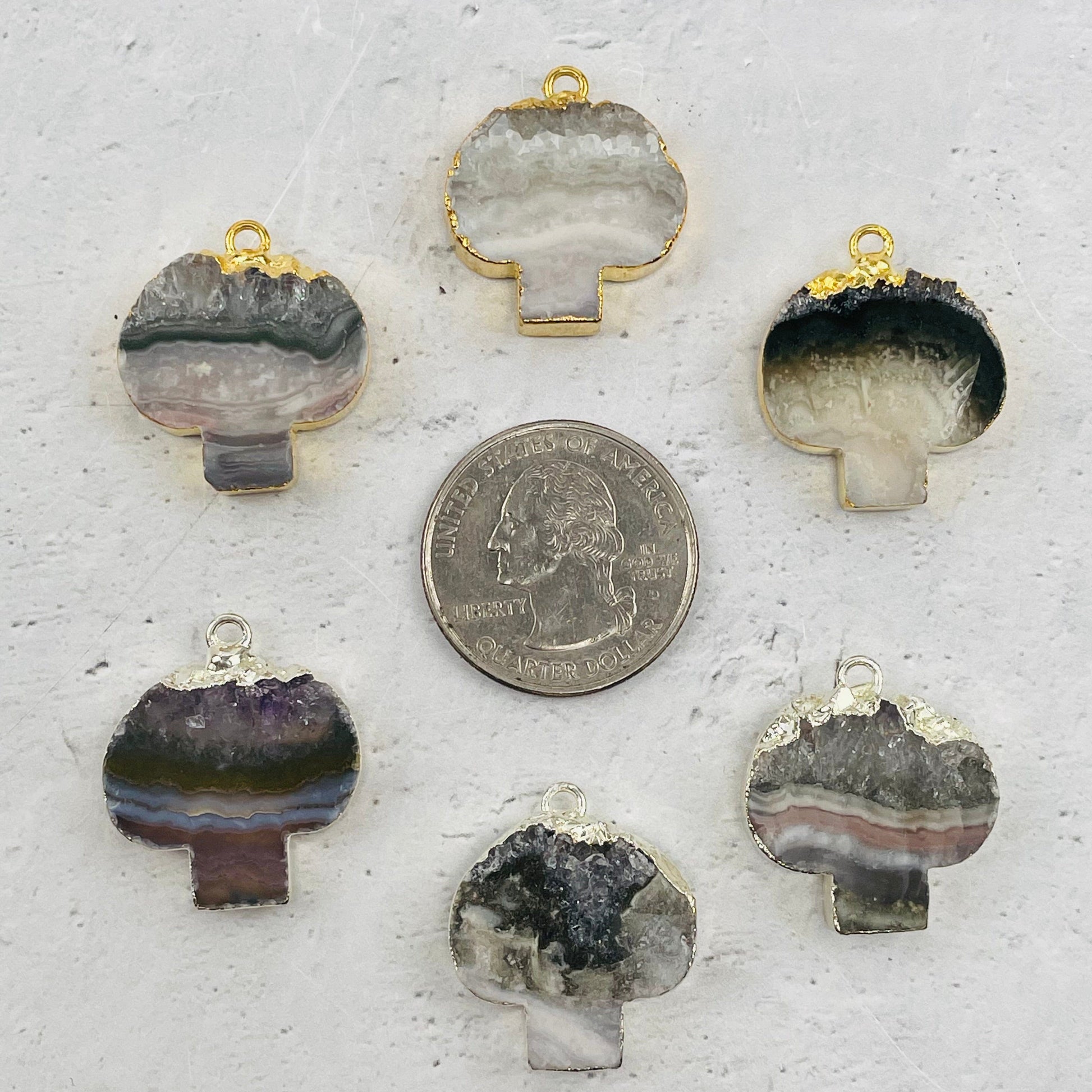 pendants next to a quarter for size reference 