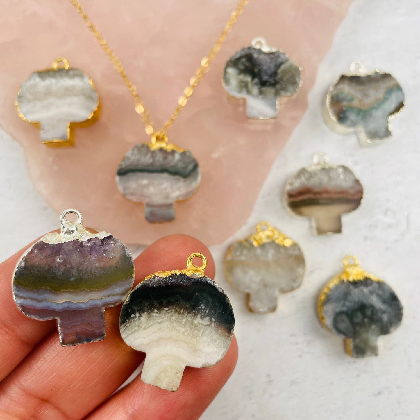 Amethyst Mushroom Pendant with Gold or Silver Electroplated Edge in hand for size reference 