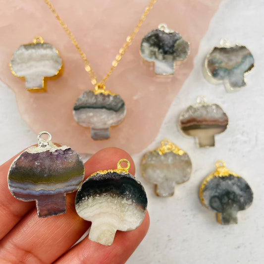 Amethyst Mushroom Pendant with Gold or Silver Electroplated Edge in hand for size reference 