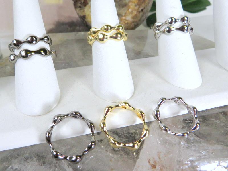 silver and gold rings stacked on a display