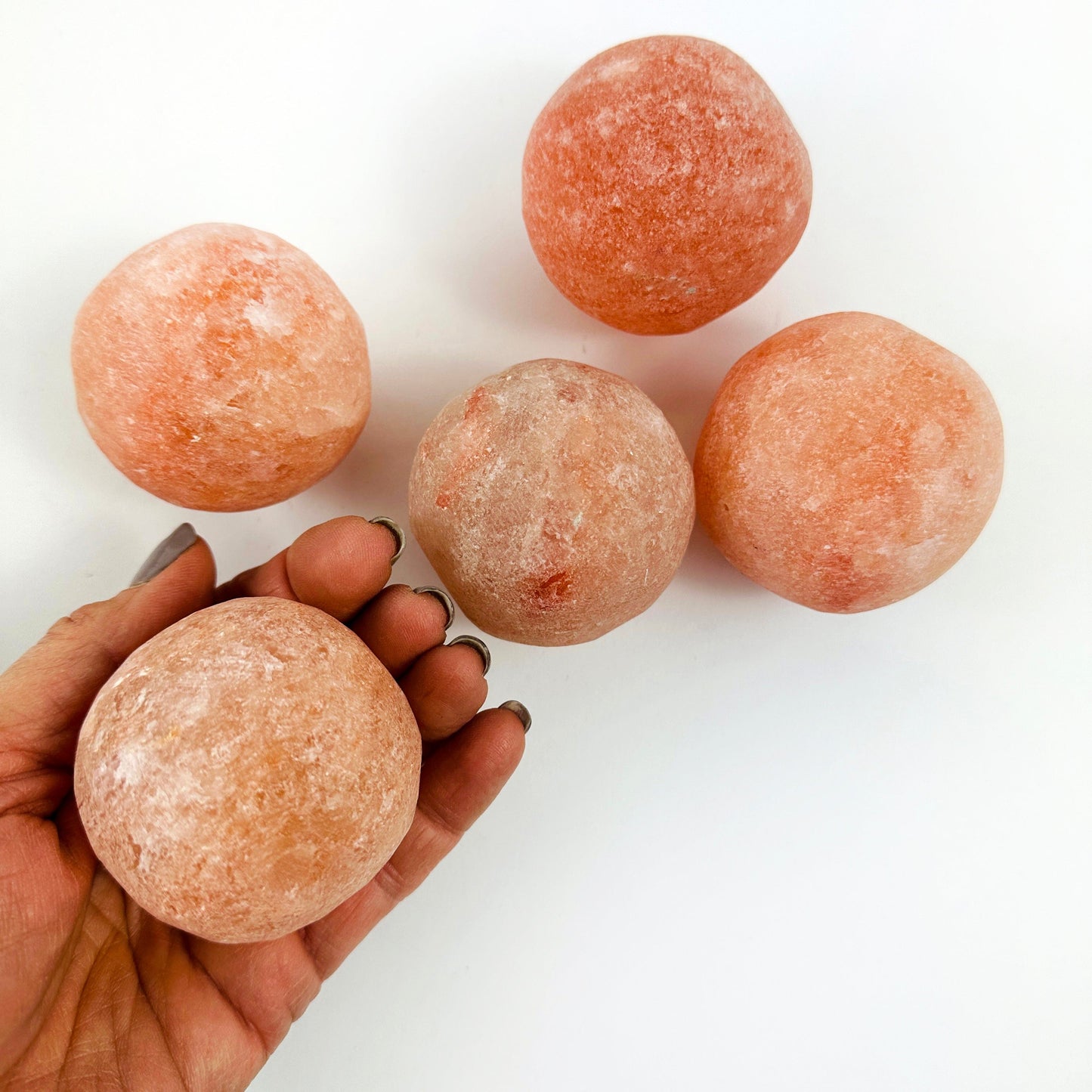 Himalayan Salt Crystal Orbs with 1 in a hand