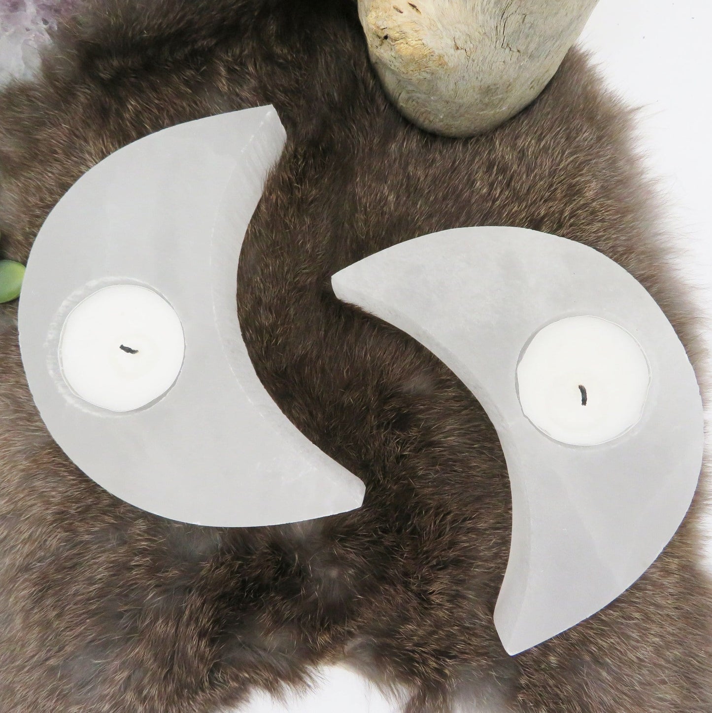 overhead view of selenite crescent mon candle holders on display for details and possible variations