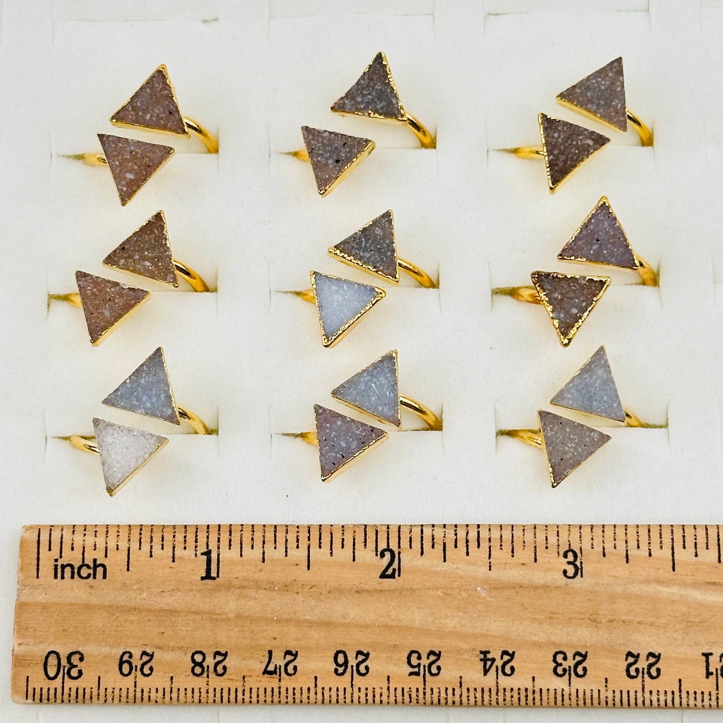 crystal rings next to a ruler for size reference  