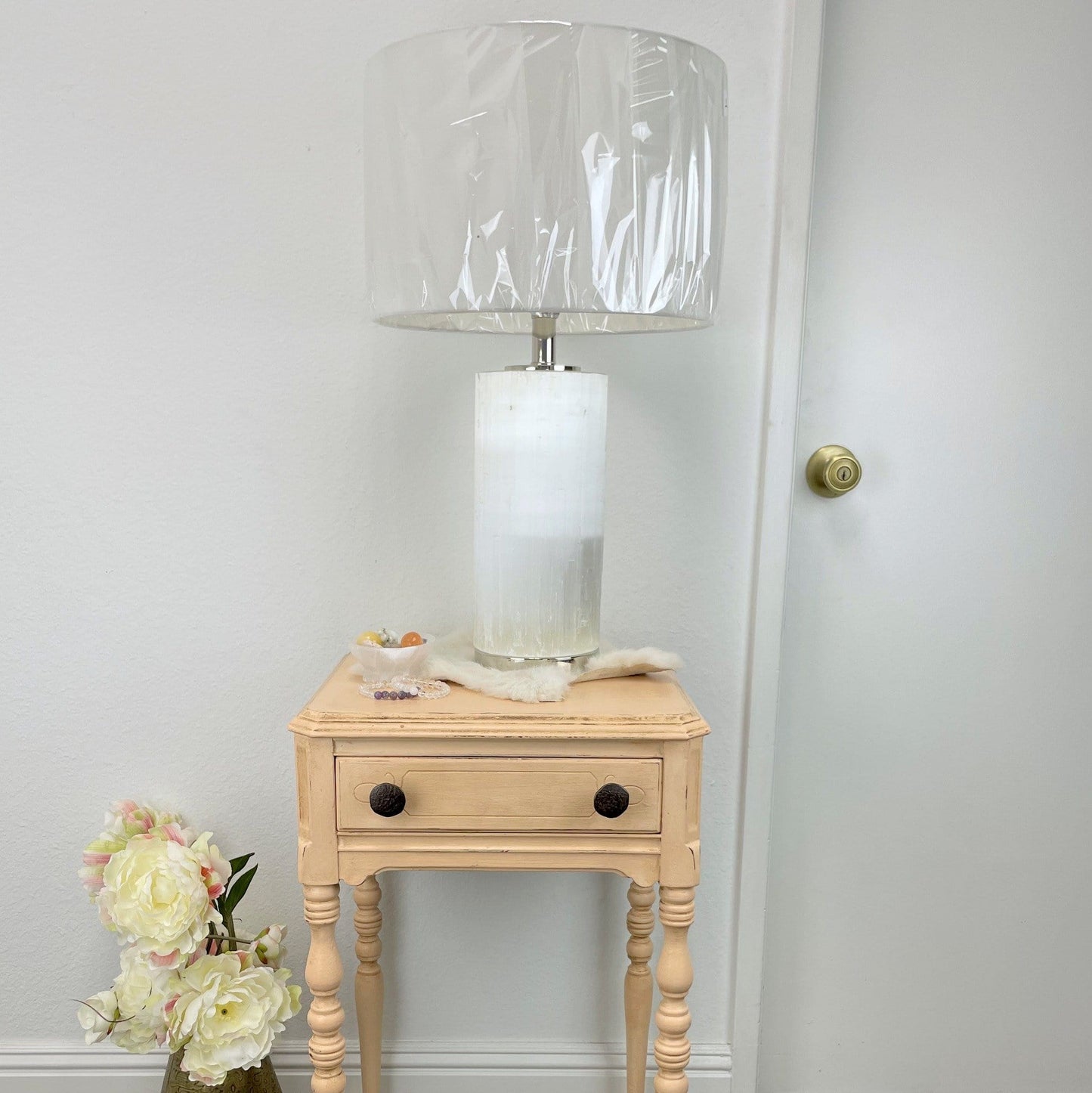 selenite lamp with silver base turned off on display