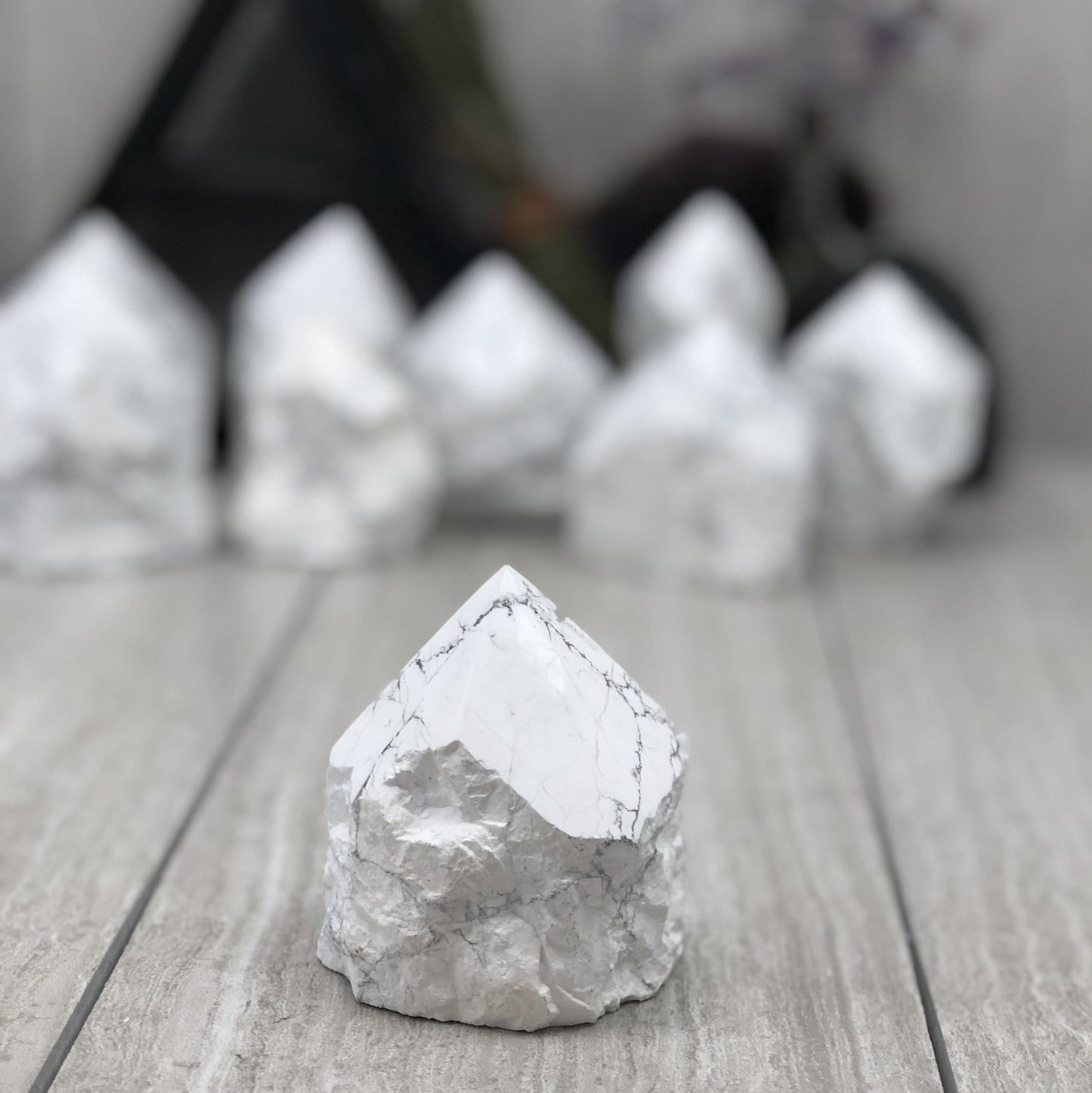 white howlite point with the top polished and the bottom left rough.