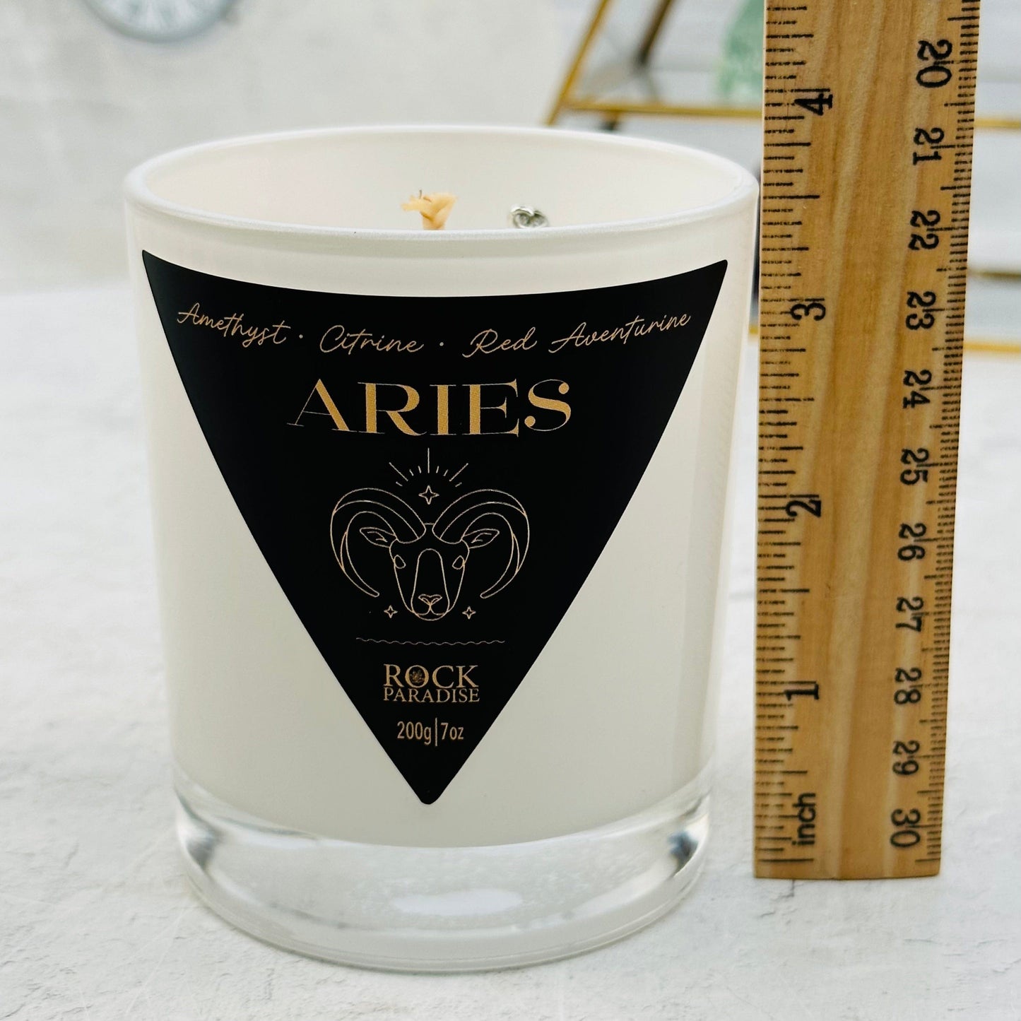 candle next to a ruler for size reference 