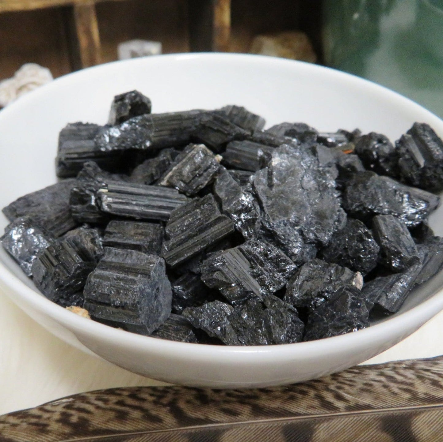 tourmaline chips in white bowl to show you can use them in a bowl for decor