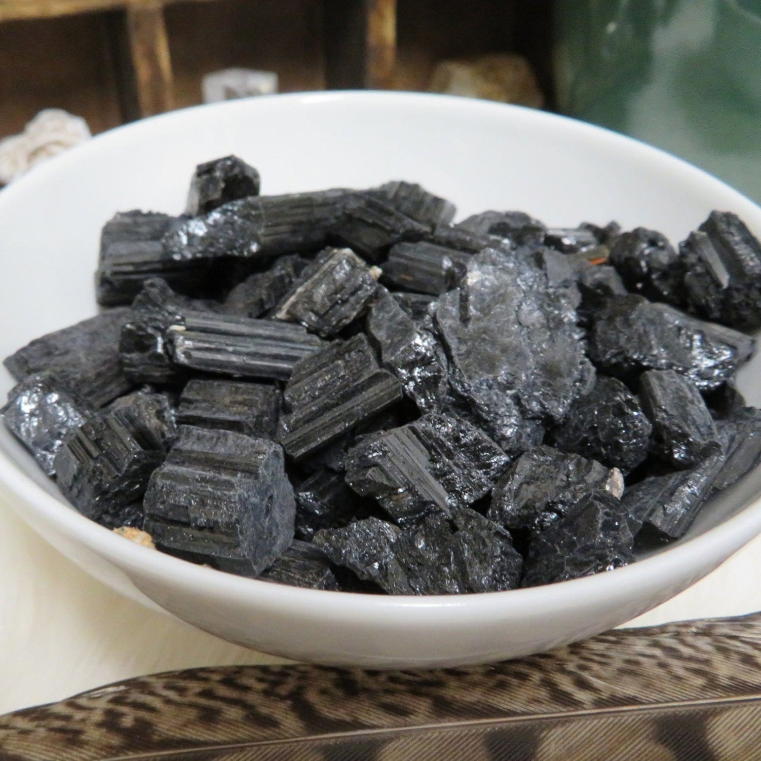 tourmaline chips in white bowl to show you can use them in a bowl for decor