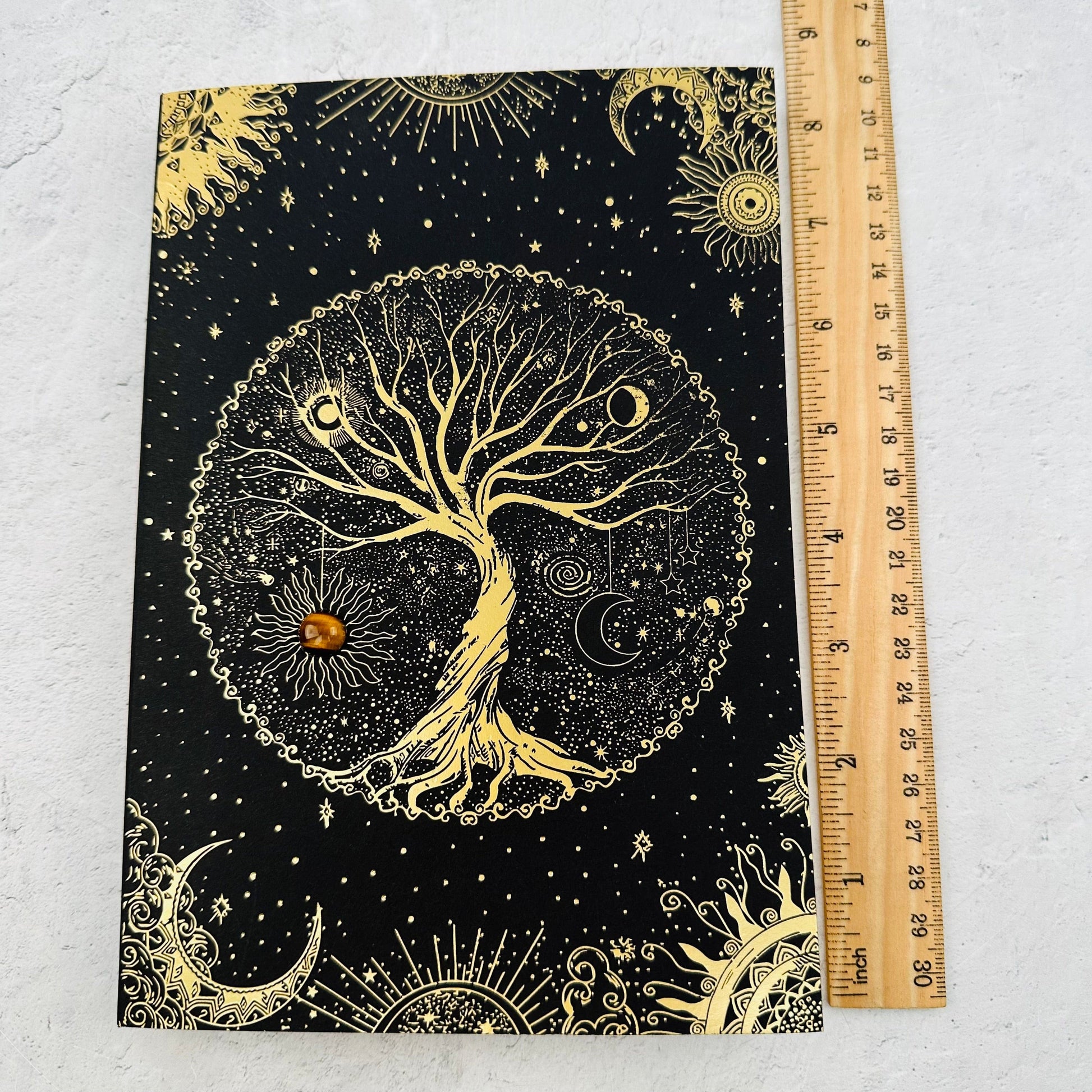 journal next to a ruler for size reference 