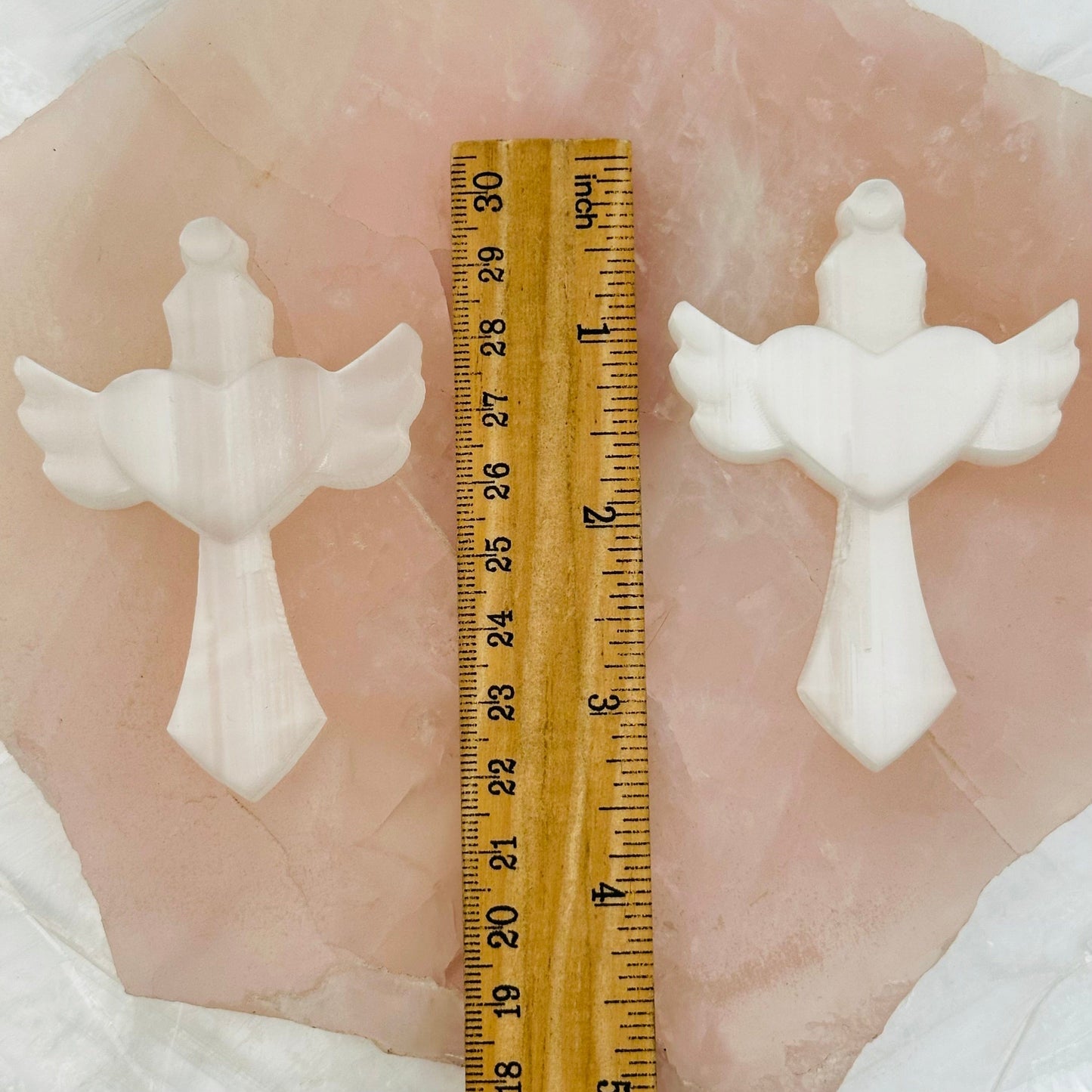 crosses next to a ruler for size reference 