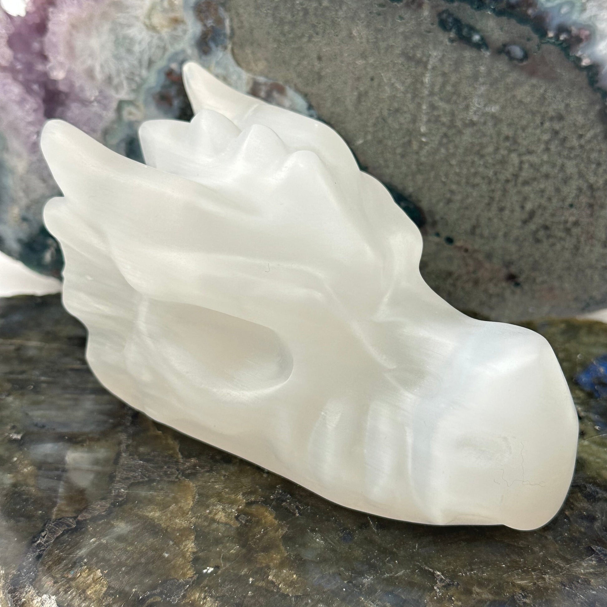 close up of the engraved details on this selenite dragon head