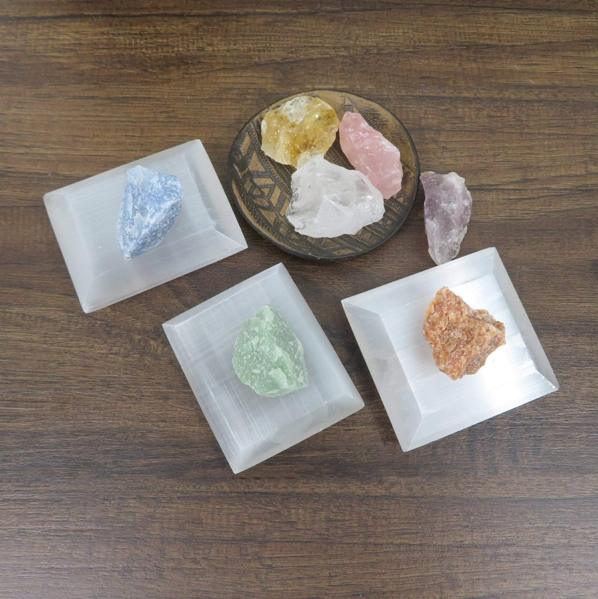 overhead view of selenite square charging plates on display with charging stones