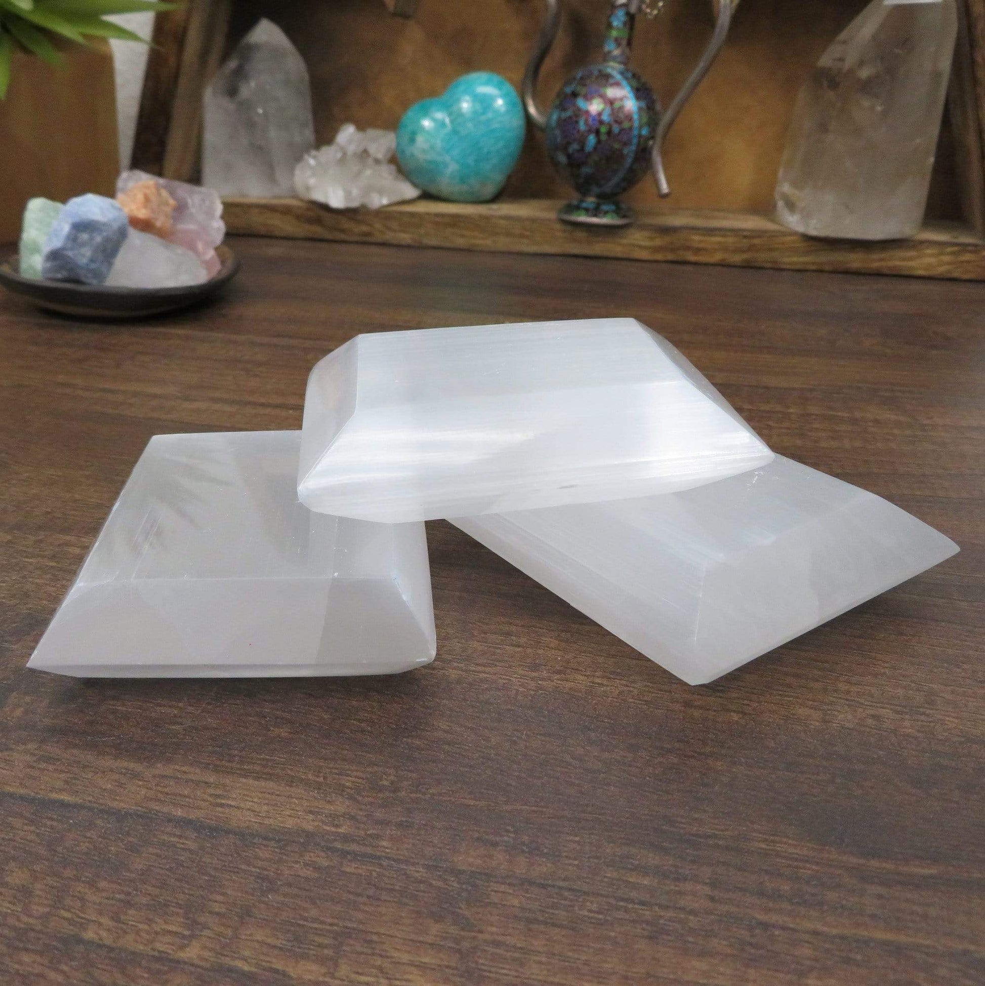 three selenite square charging plates on display