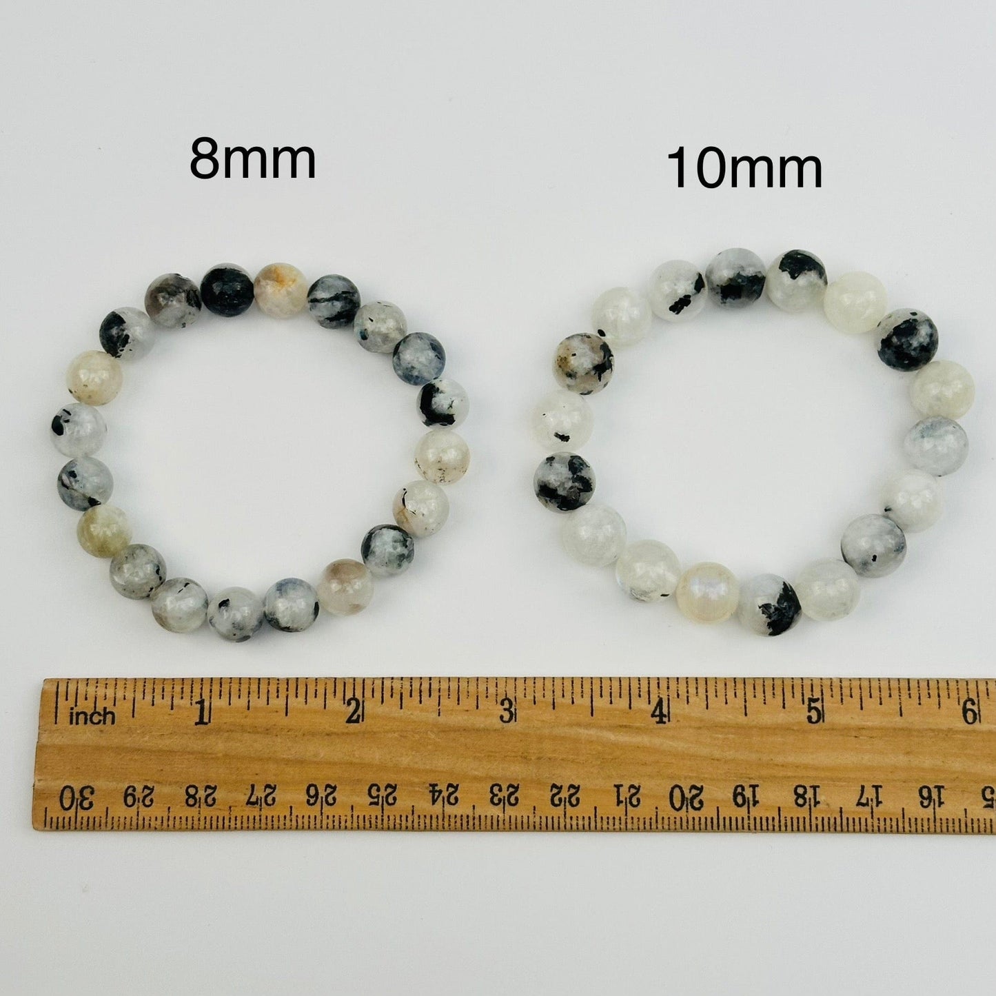 high quality moonstone bracelets displayed next to a ruler for size reference 
