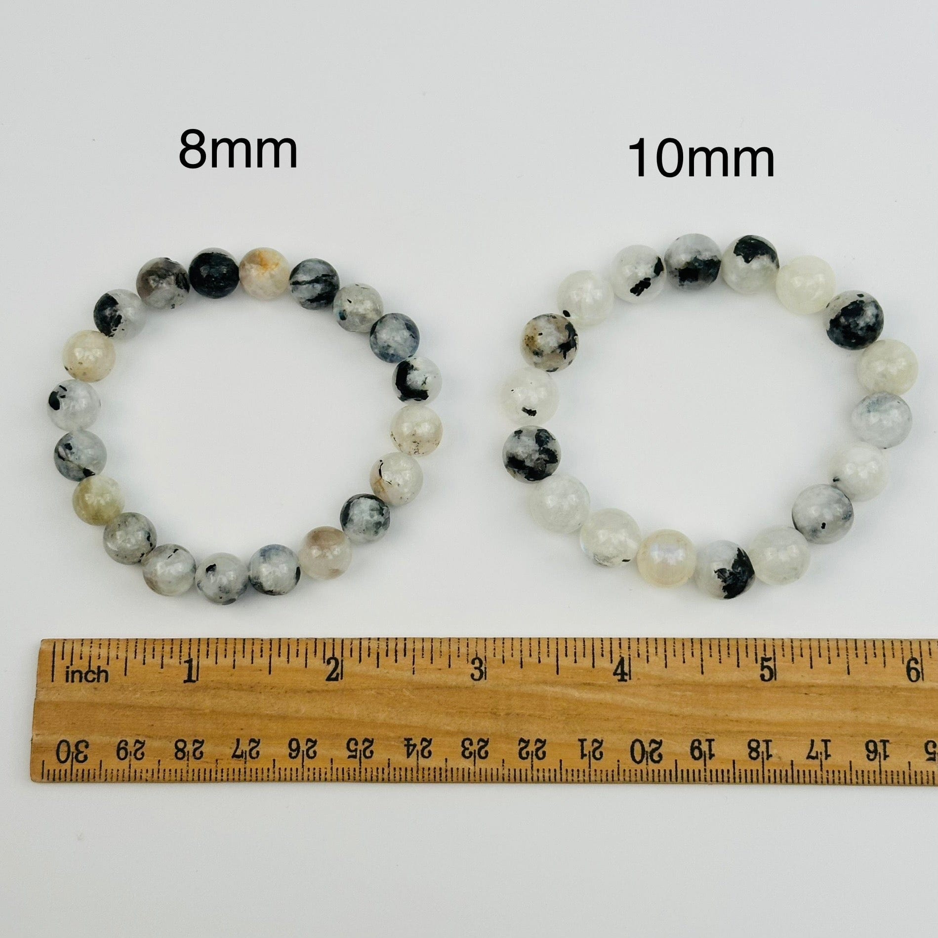 high quality moonstone bracelets displayed next to a ruler for size reference 