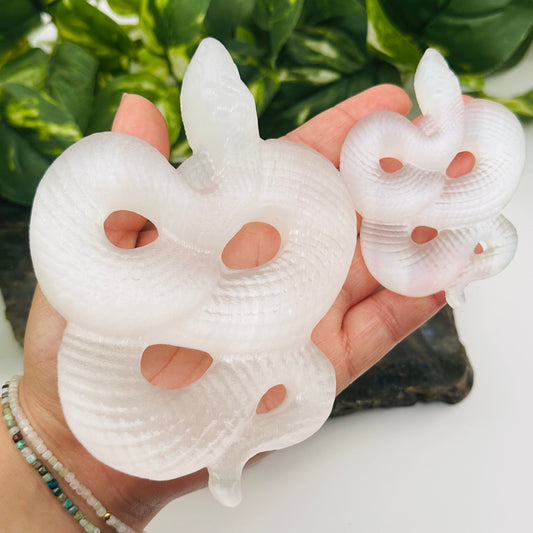 selenite crystal snakes on hand for size reference 