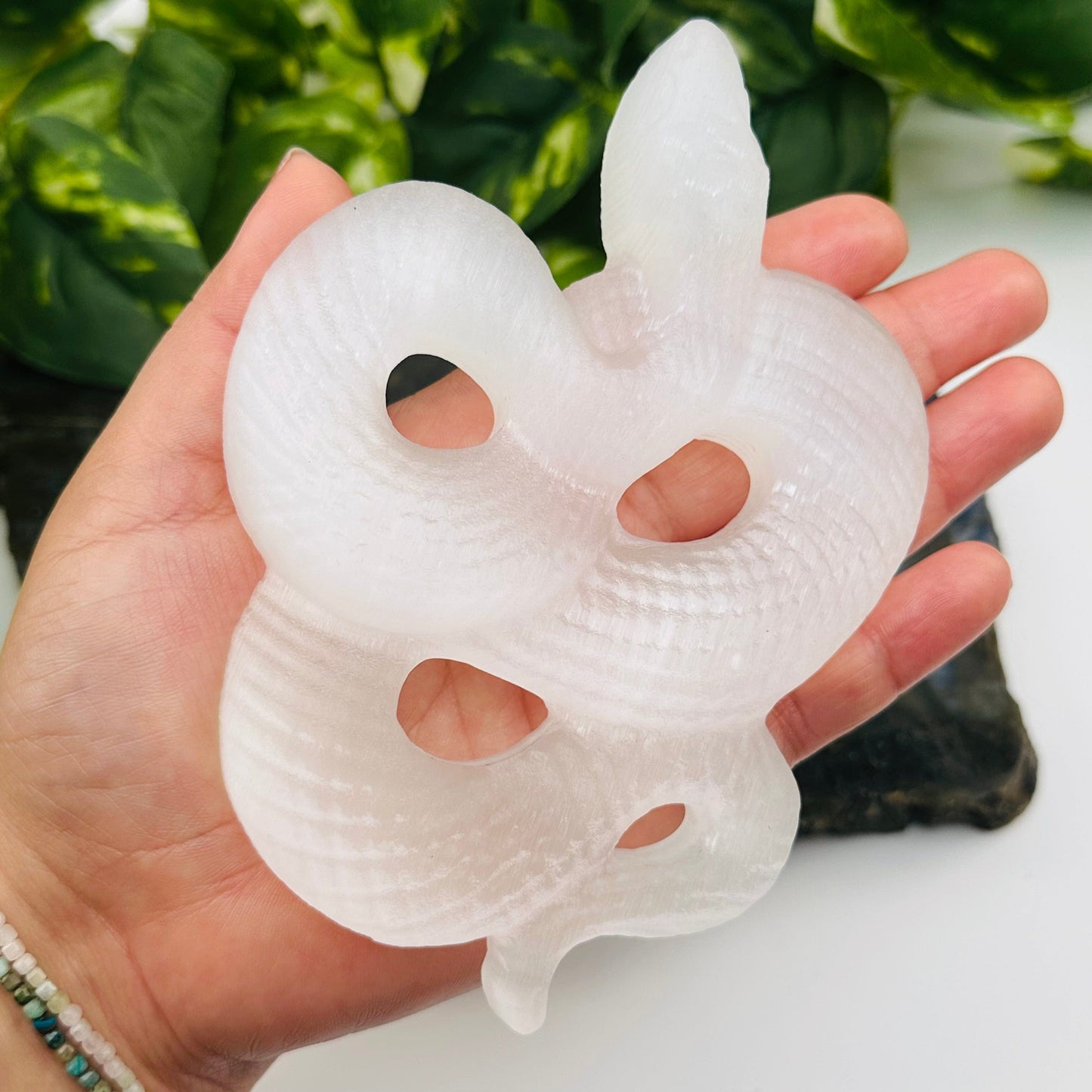 selenite crystal snake in hand for size reference 