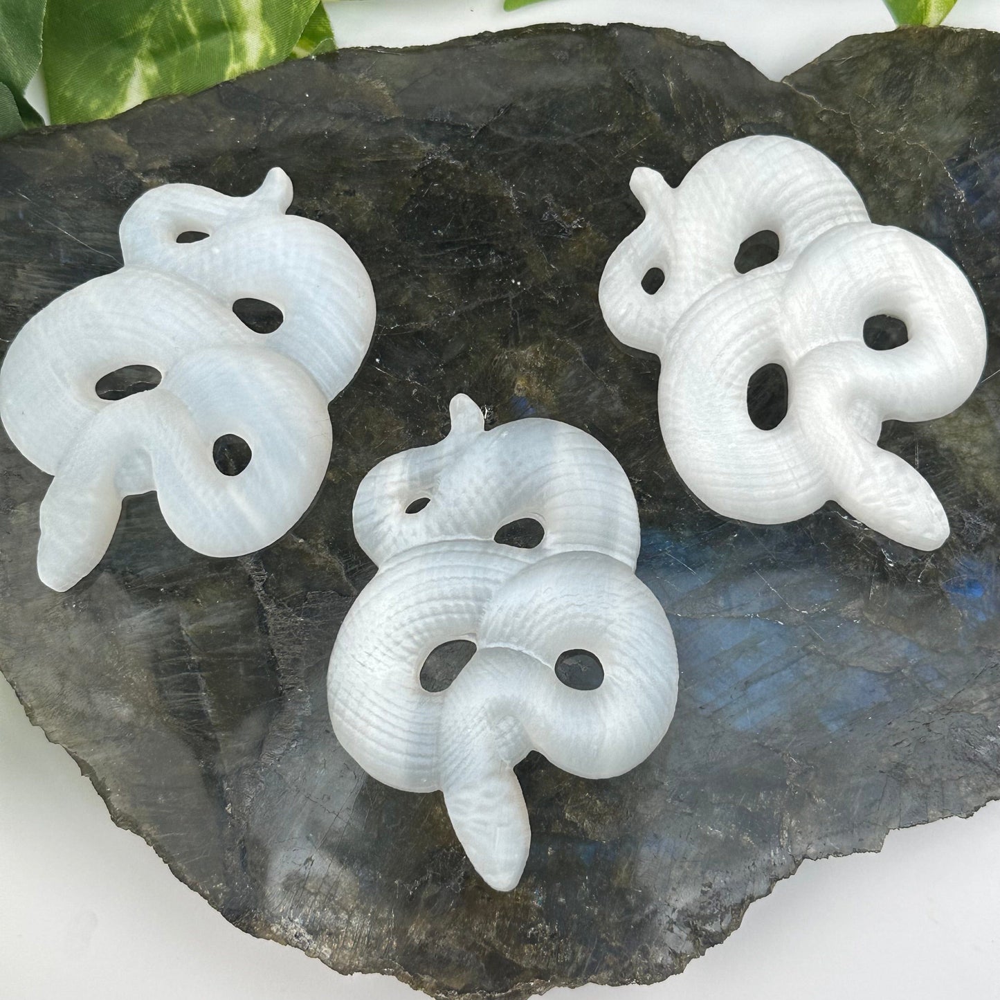 multiple selenite crystal snakes displayed to show the slight differences in the sizes