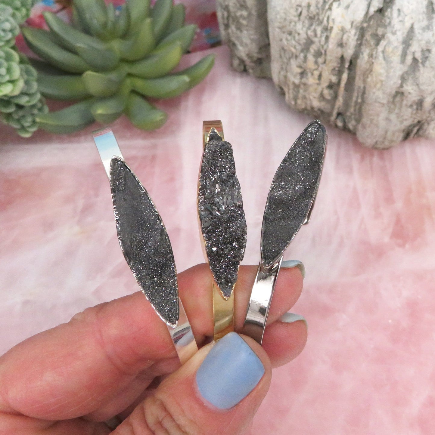 Titanium Druzy Stone Bracelets fanned in a hand