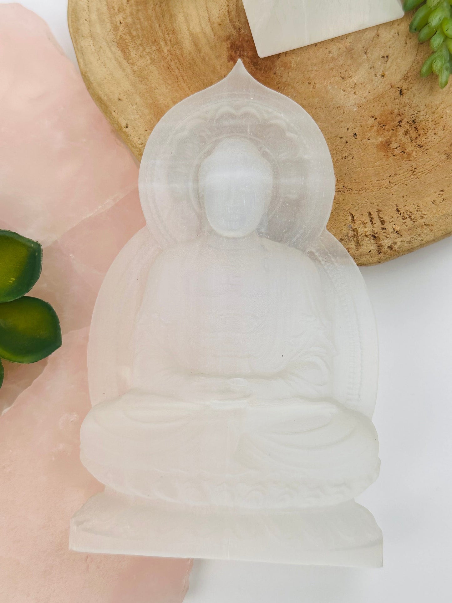 buddha selenite carving displayed as home decor