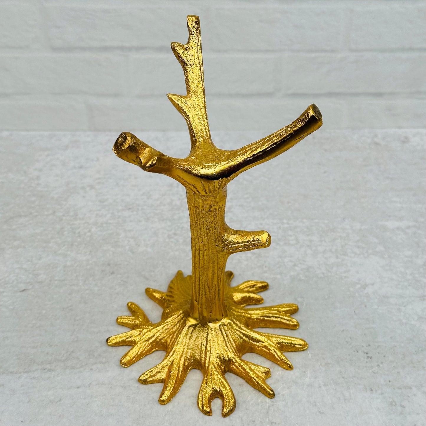 close up of the details on the gold tree stand 