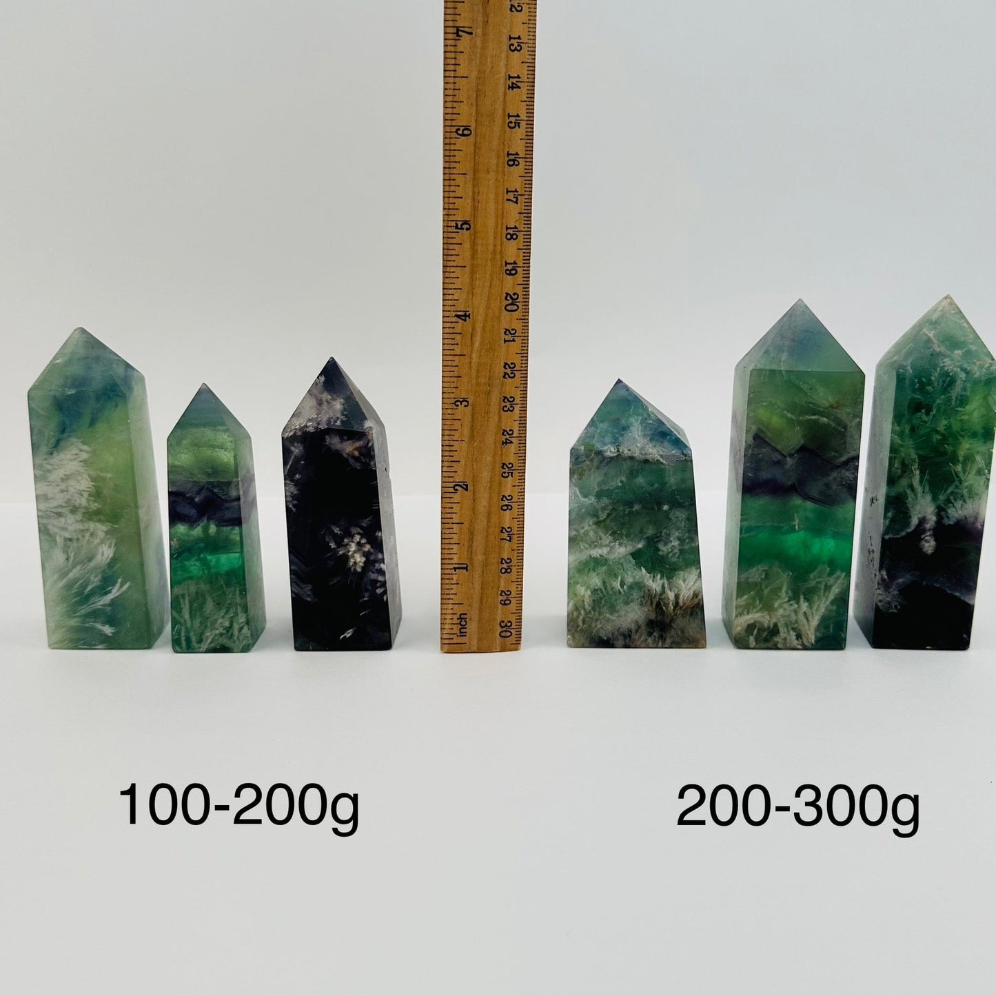 crystal points sold by weight. displayed next to a ruler for size reference 