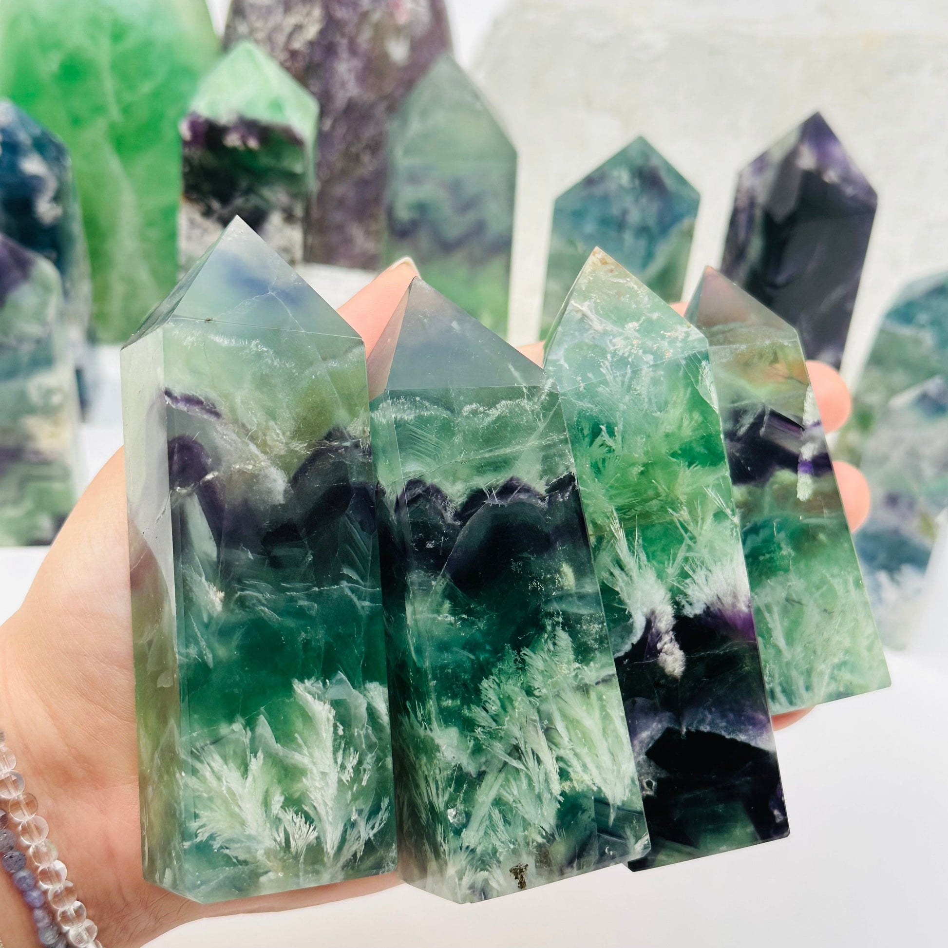 Rainbow Feathered Fluorite Crystal Points in hand for size reference 