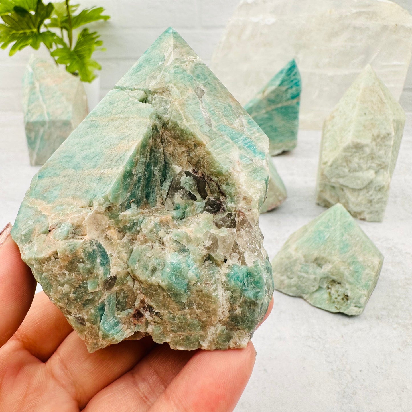 Amazonite Semi Polished Point in hand for size reference 