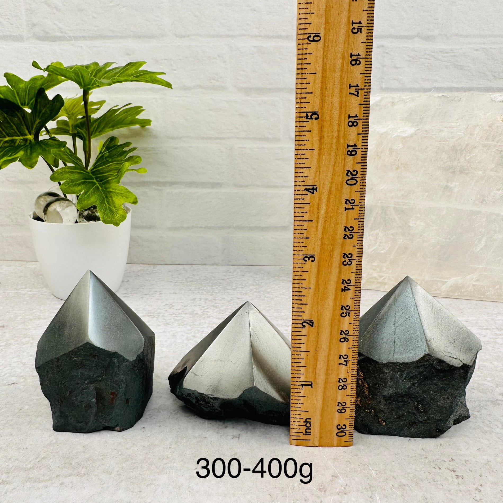Hematite Semi-Polished Points - By Weight next to a ruler for size reference 