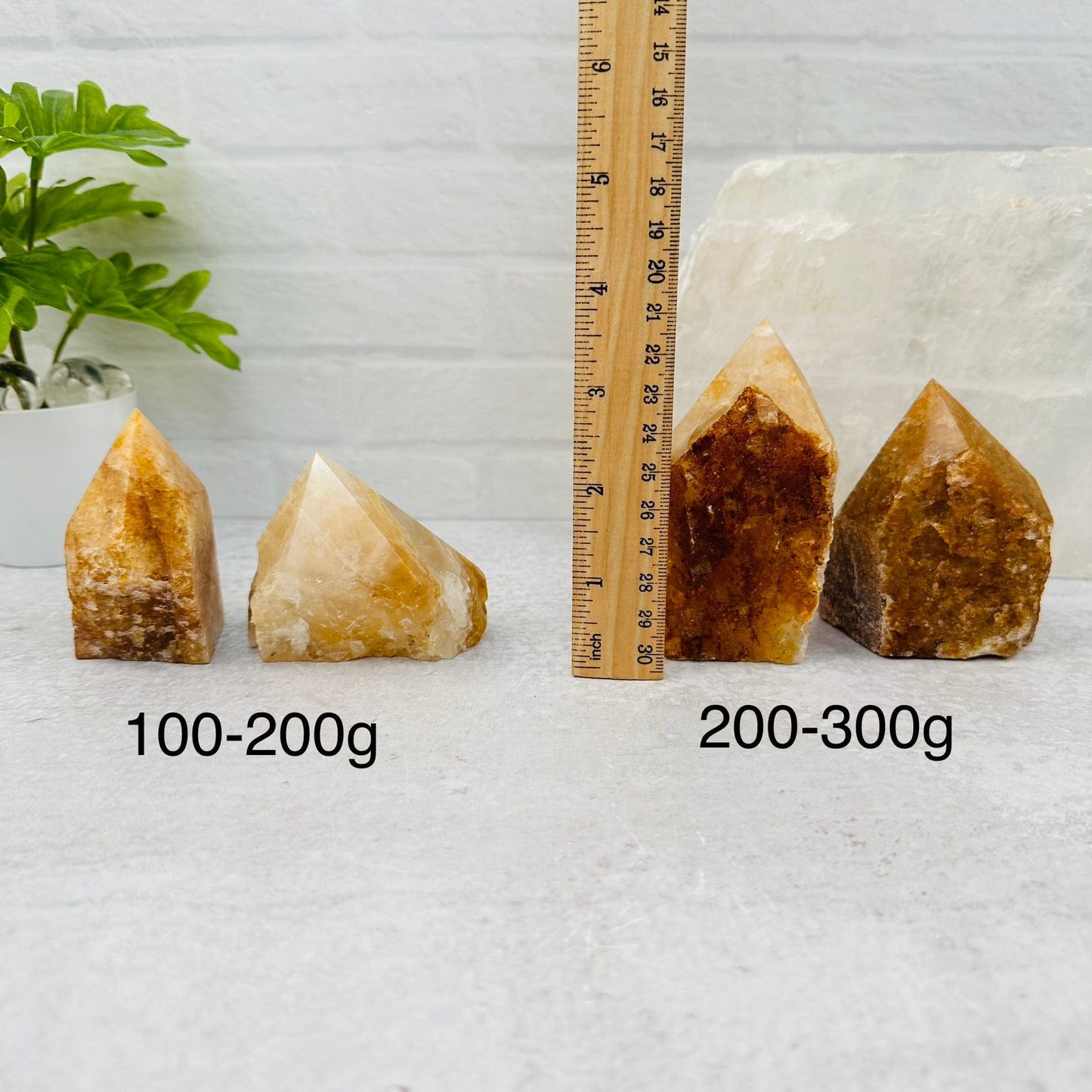 Golden Healer Semi Polished Point - By Weight next to a ruler for size reference 