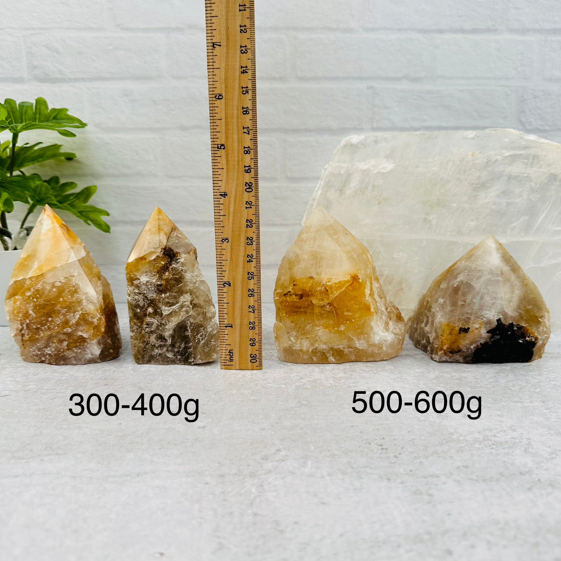 Golden Healer Semi Polished Point - By Weight next to a ruler for size reference