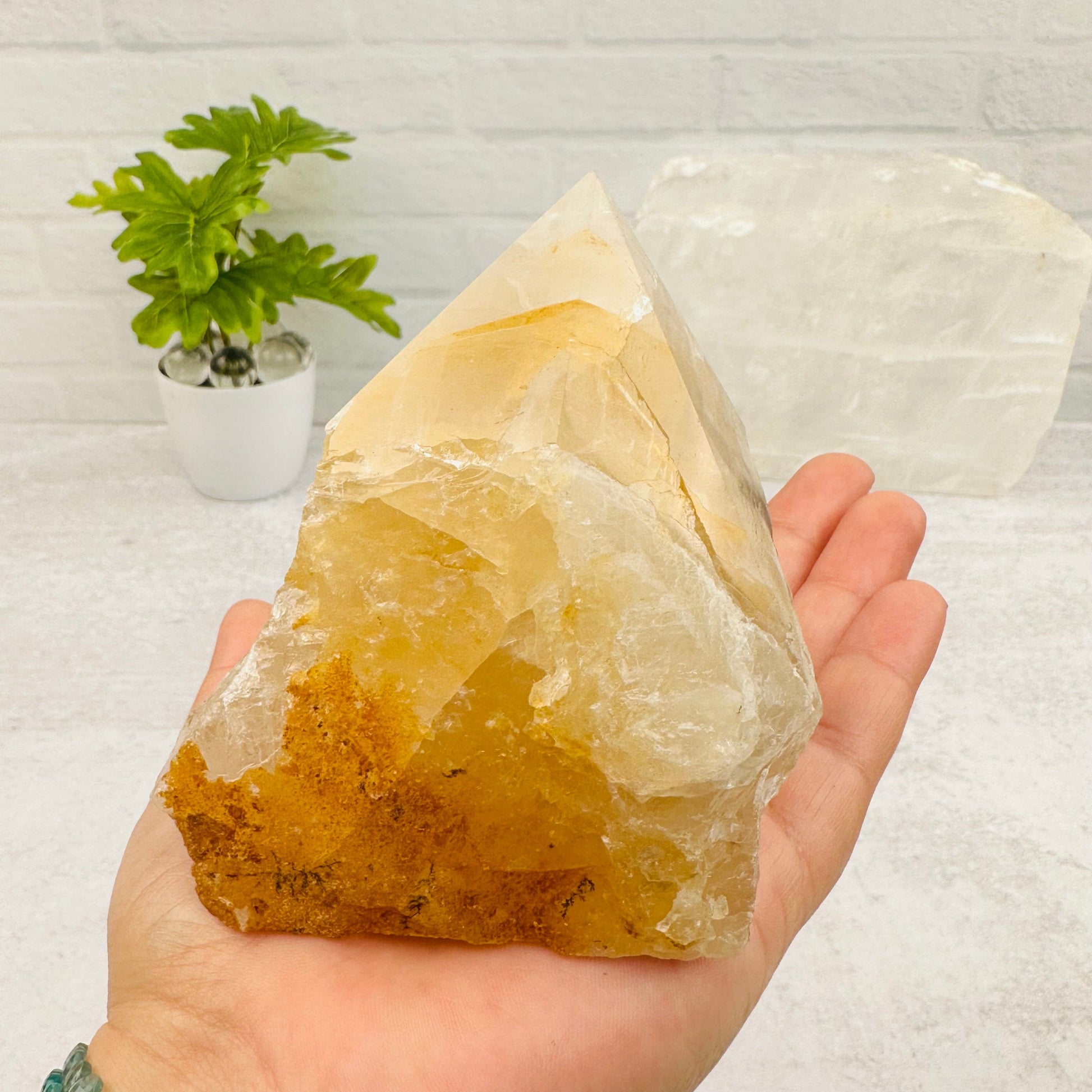 Golden Healer Semi Polished Point in hand for size reference 