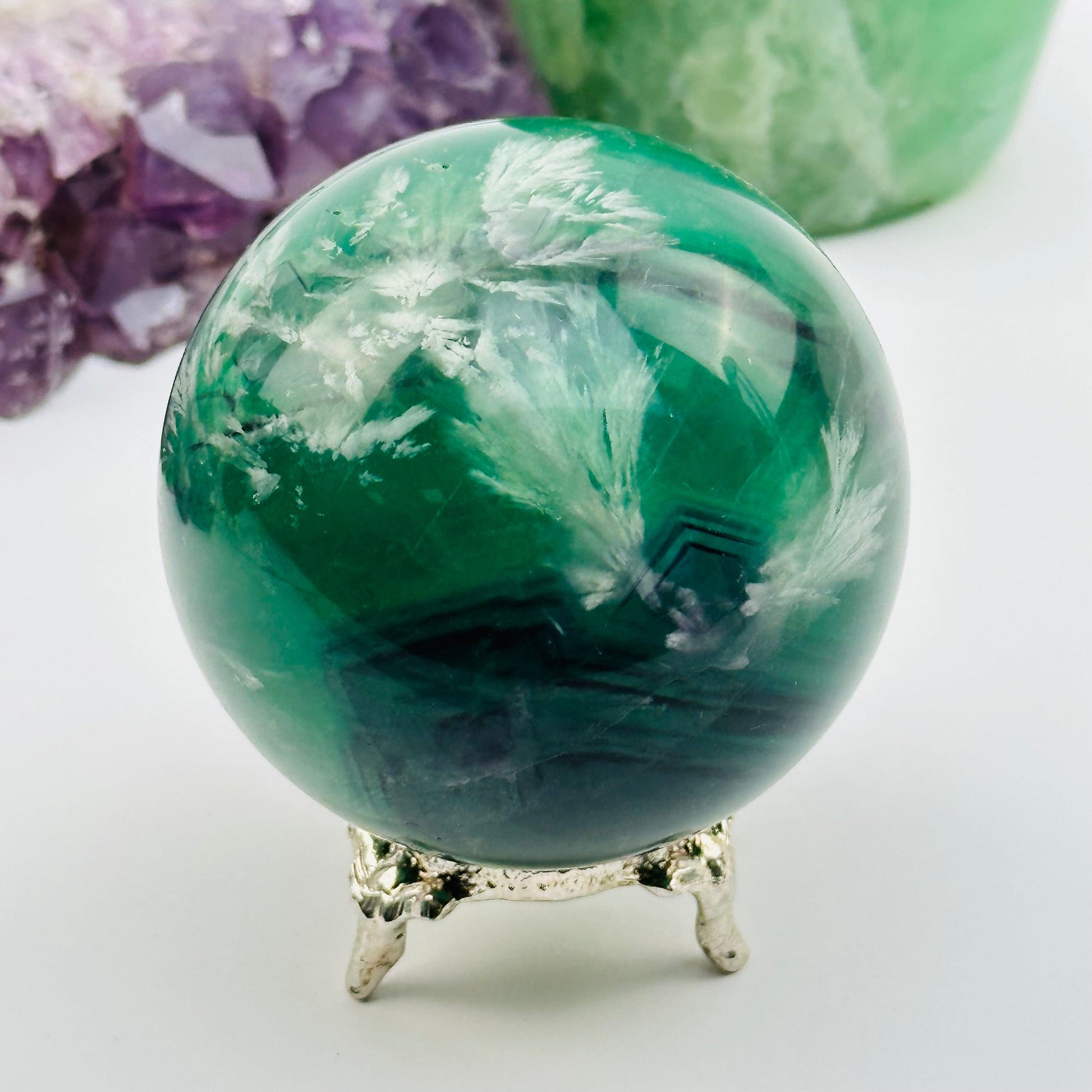 feather fluorite crystal sphere displayed as home decor