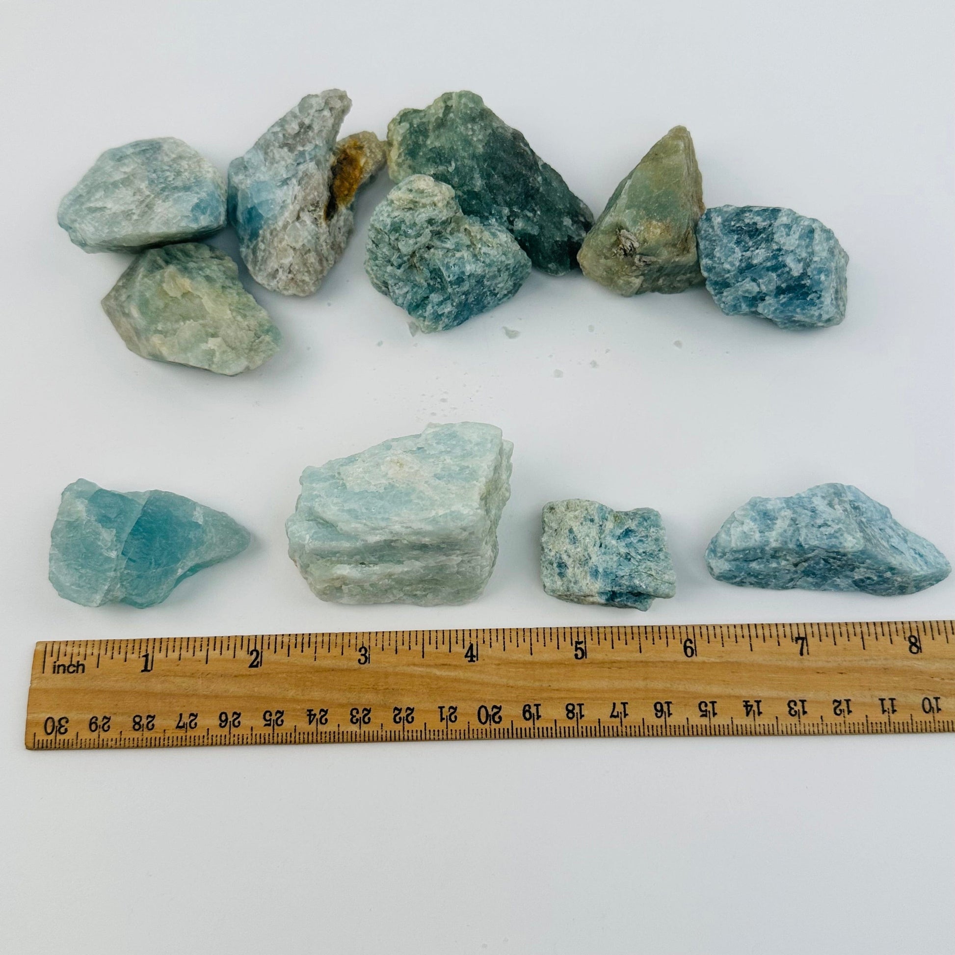aquamarine next to a ruler for size reference 