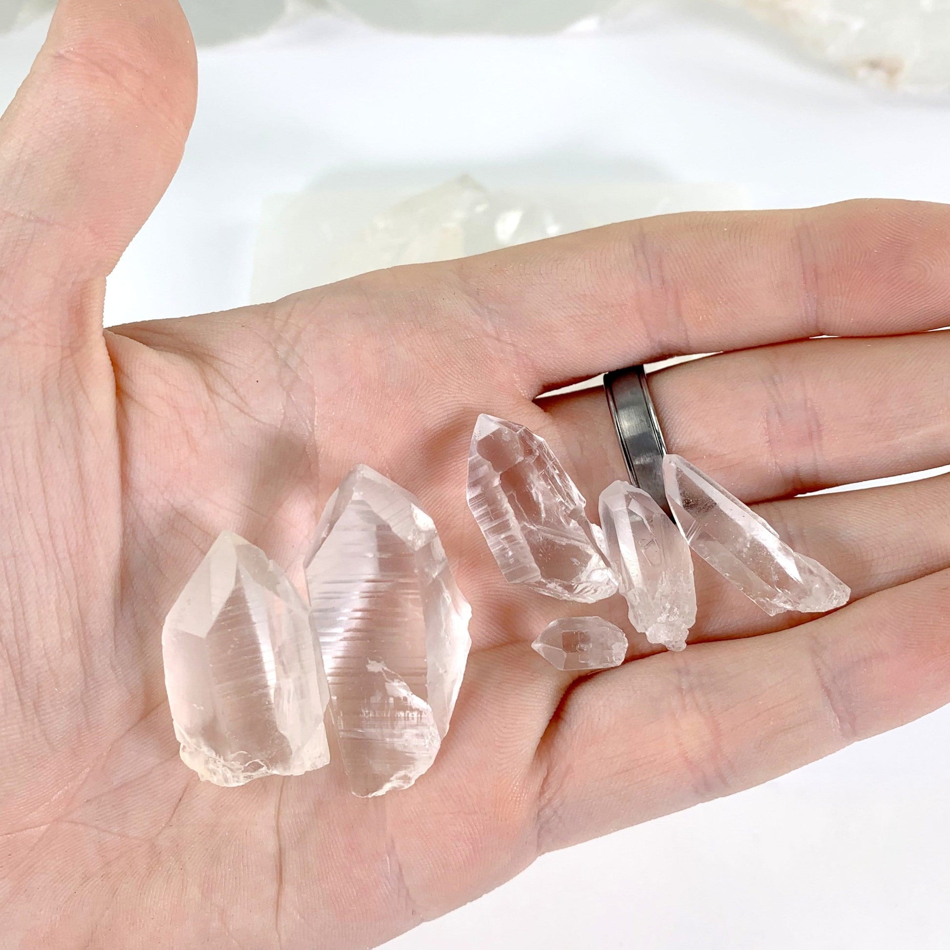 Natural Lemurian Quartz Points - hand holding several pieces