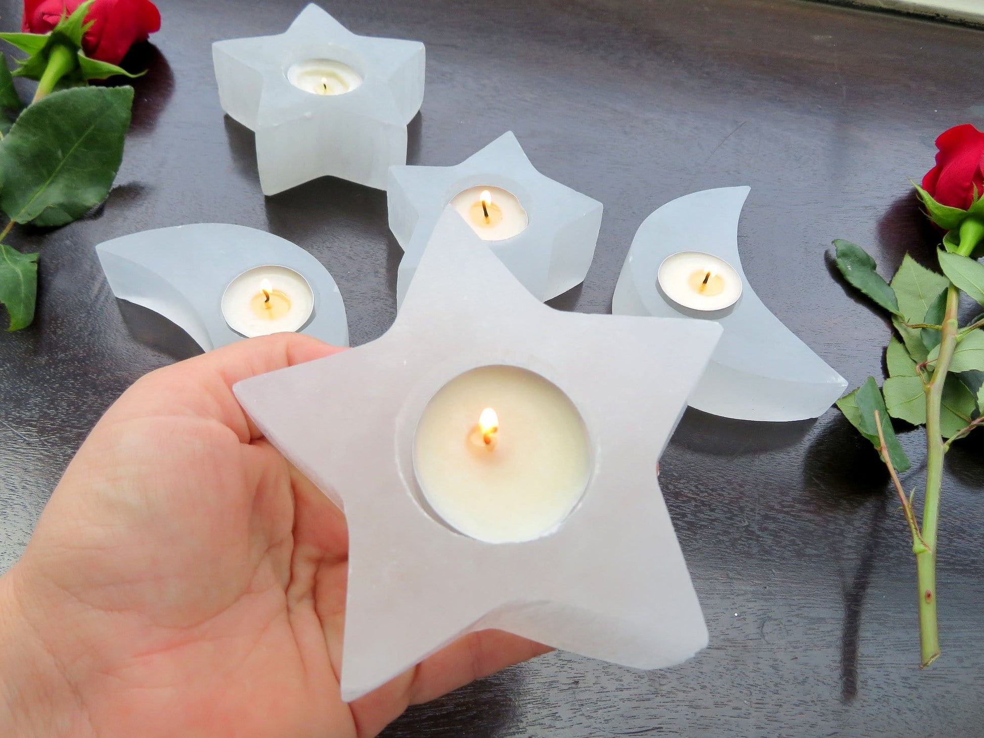 selenite star candle holder in hand for size reference