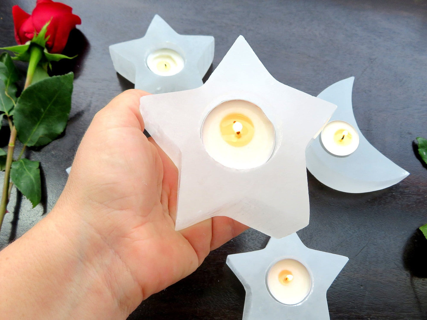 selenite star candle holder in hand for size reference