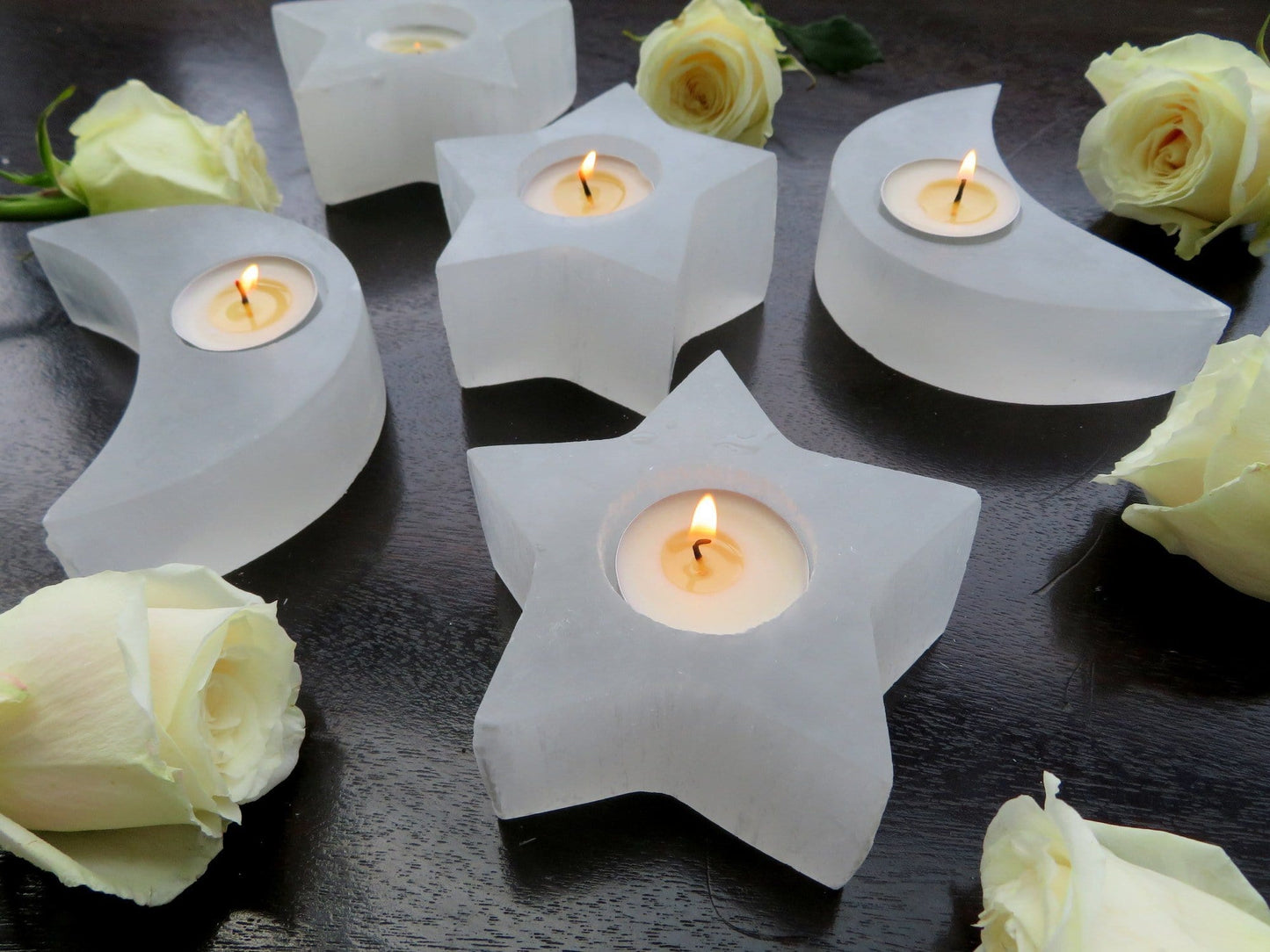 selenite star and moon candle holders on display