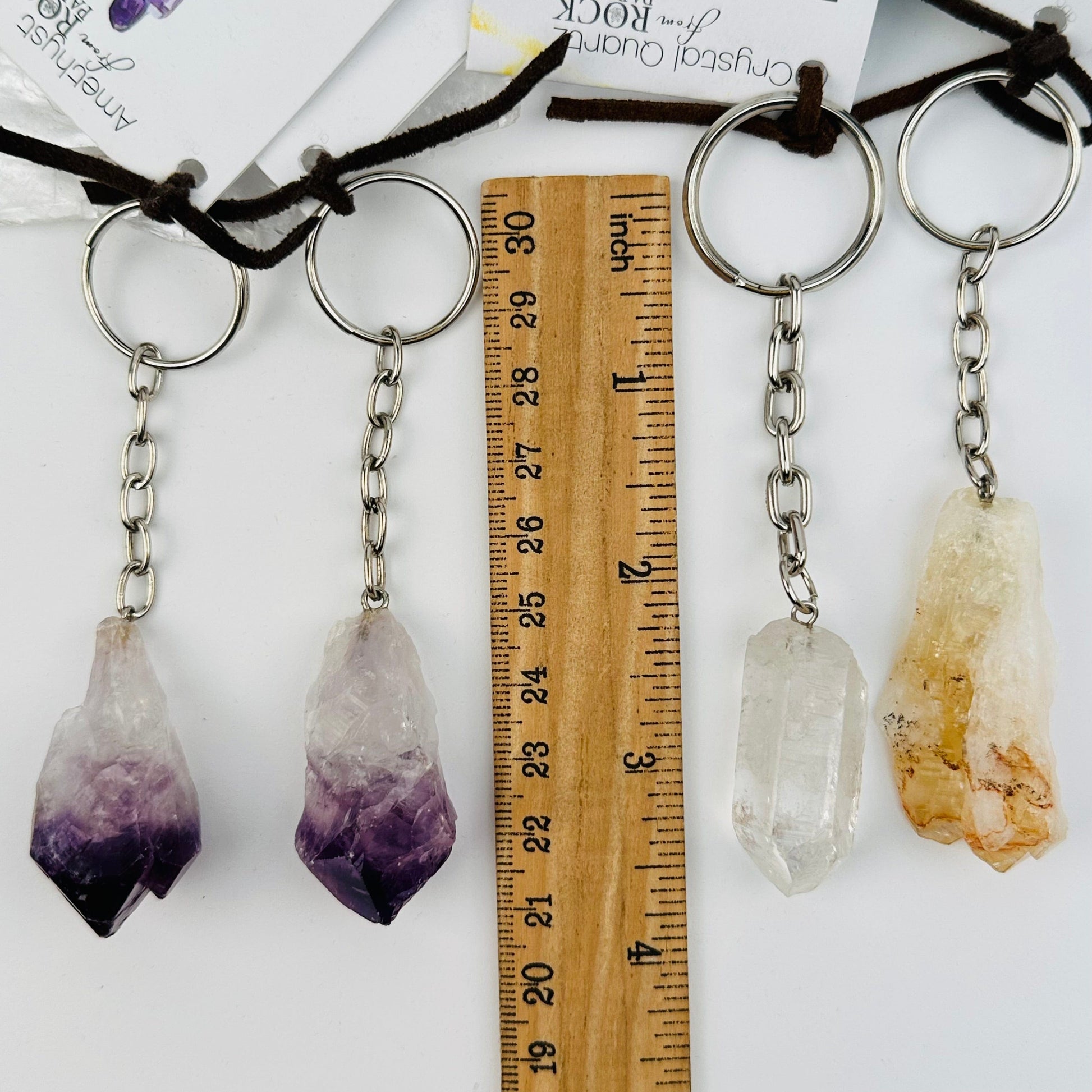 key chains displayed next to a ruler for size reference 