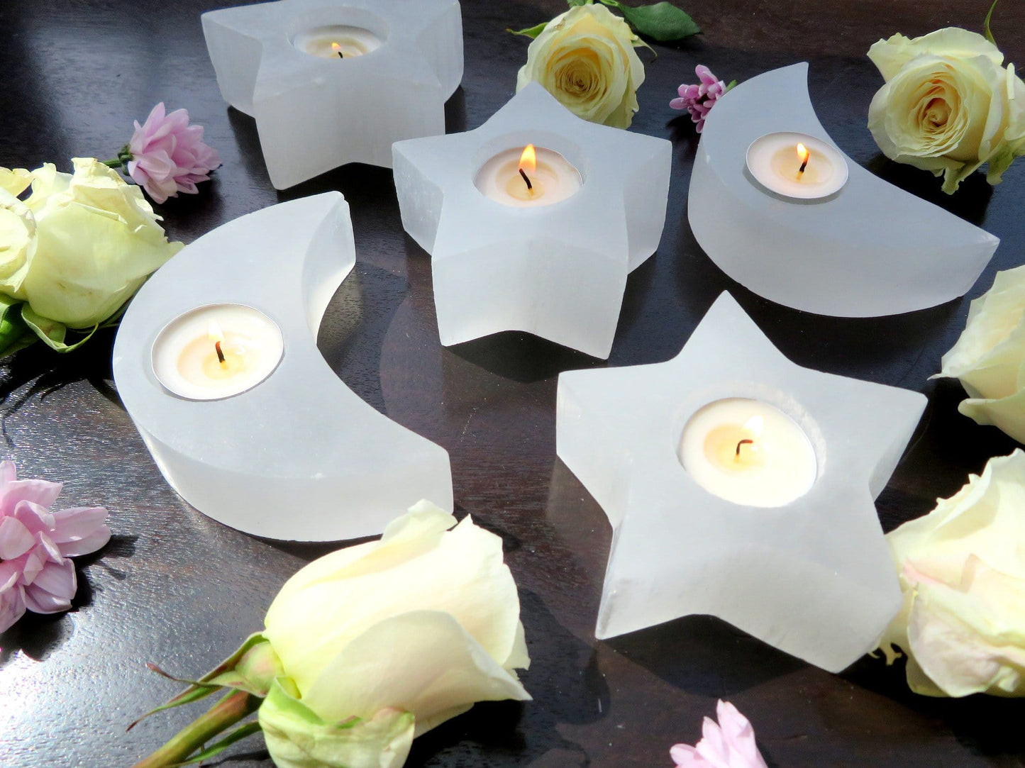 selenite crescent moon and star candle holders on display