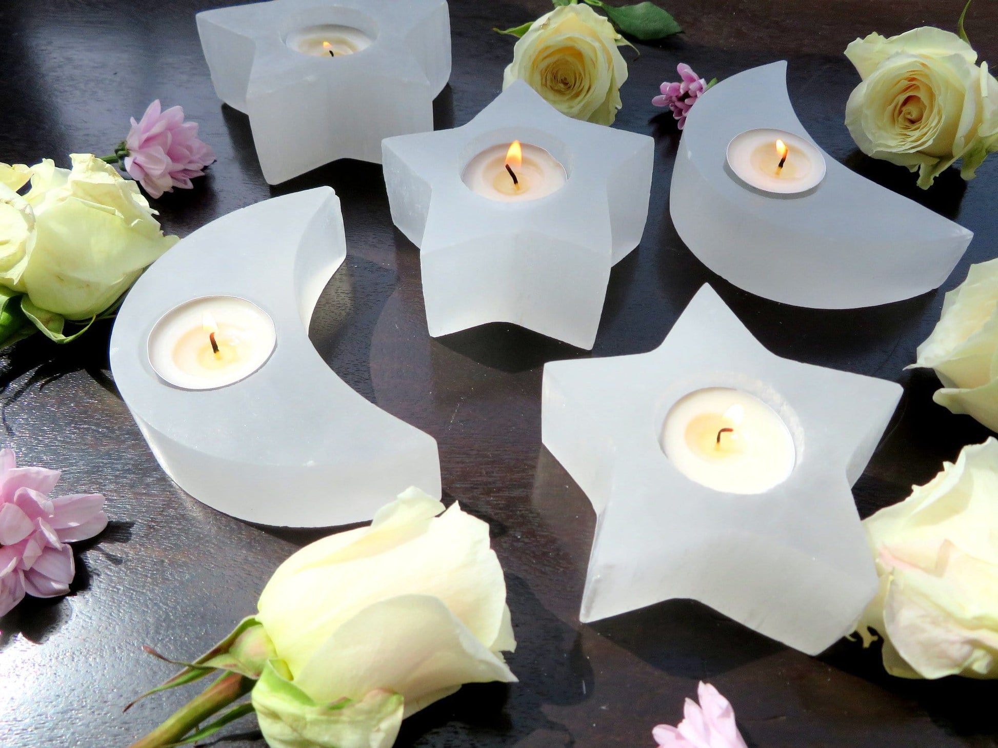selenite crescent moon and star candle holders on display