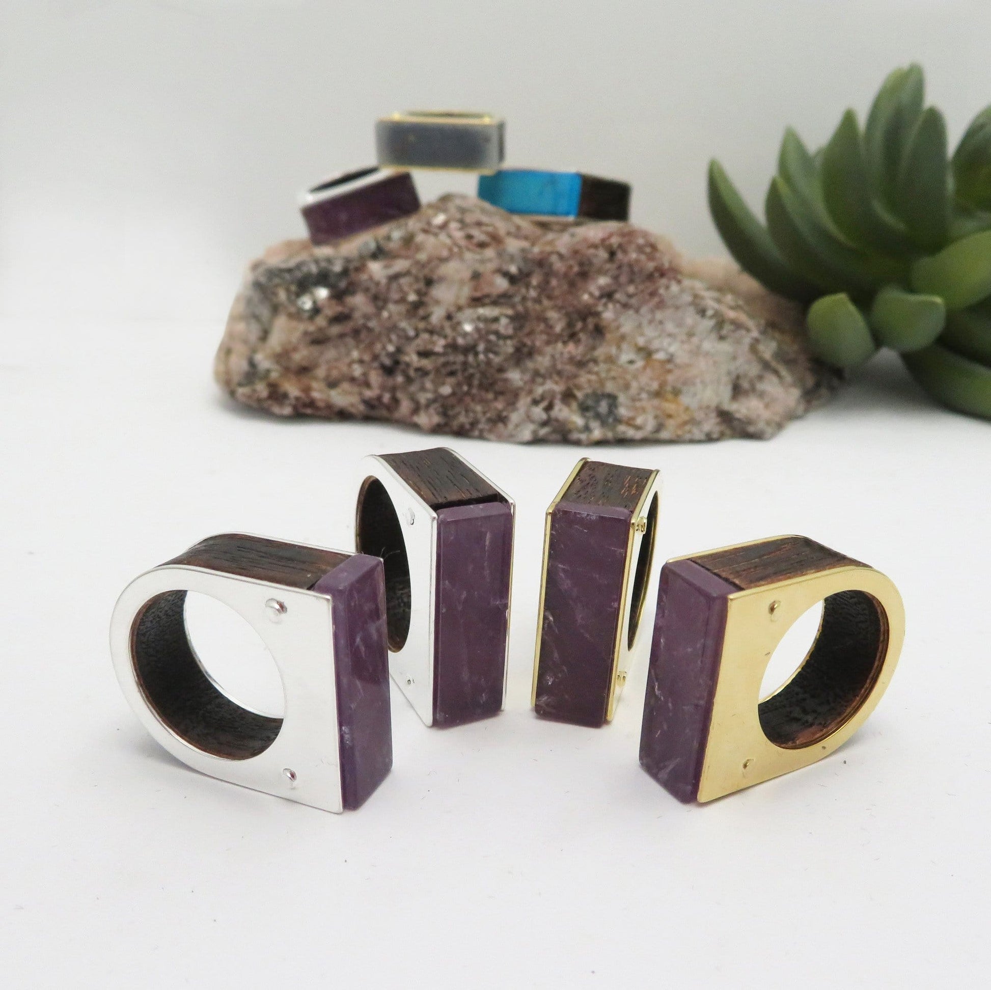 4 amethyst rings on a white background.