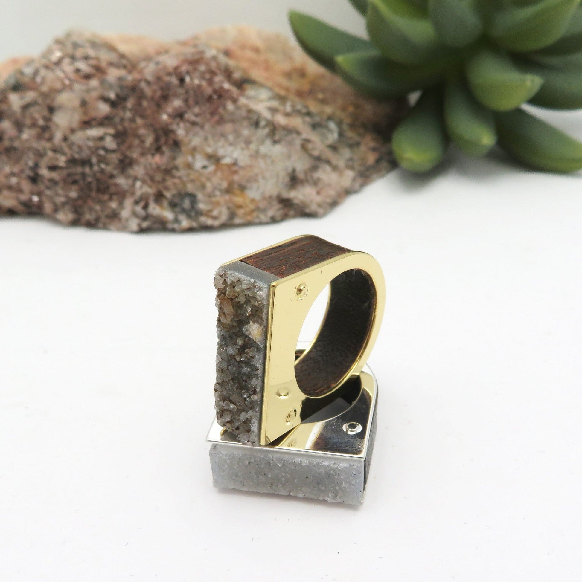 Gold and silver druzy ring on a white background