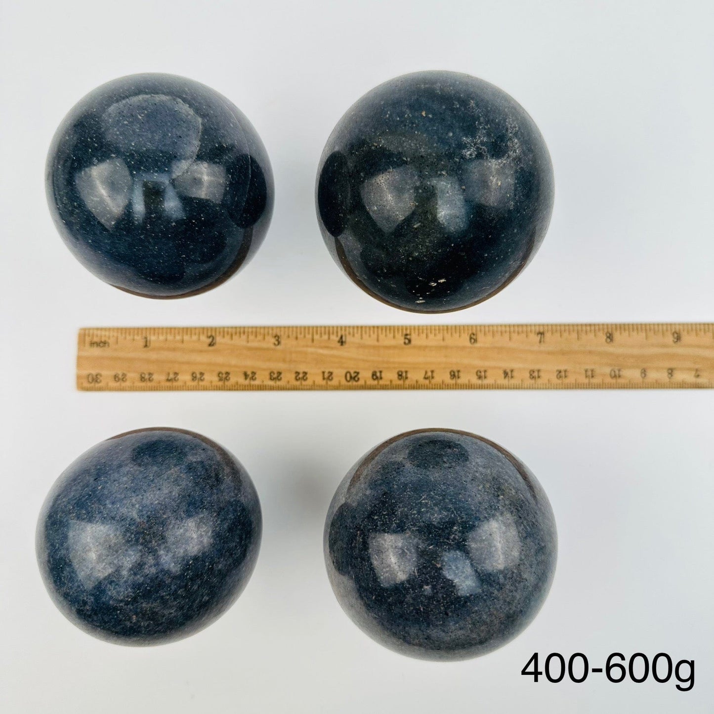 lazulite crystal spheres sold by weight. displayed next to a ruler for size reference 