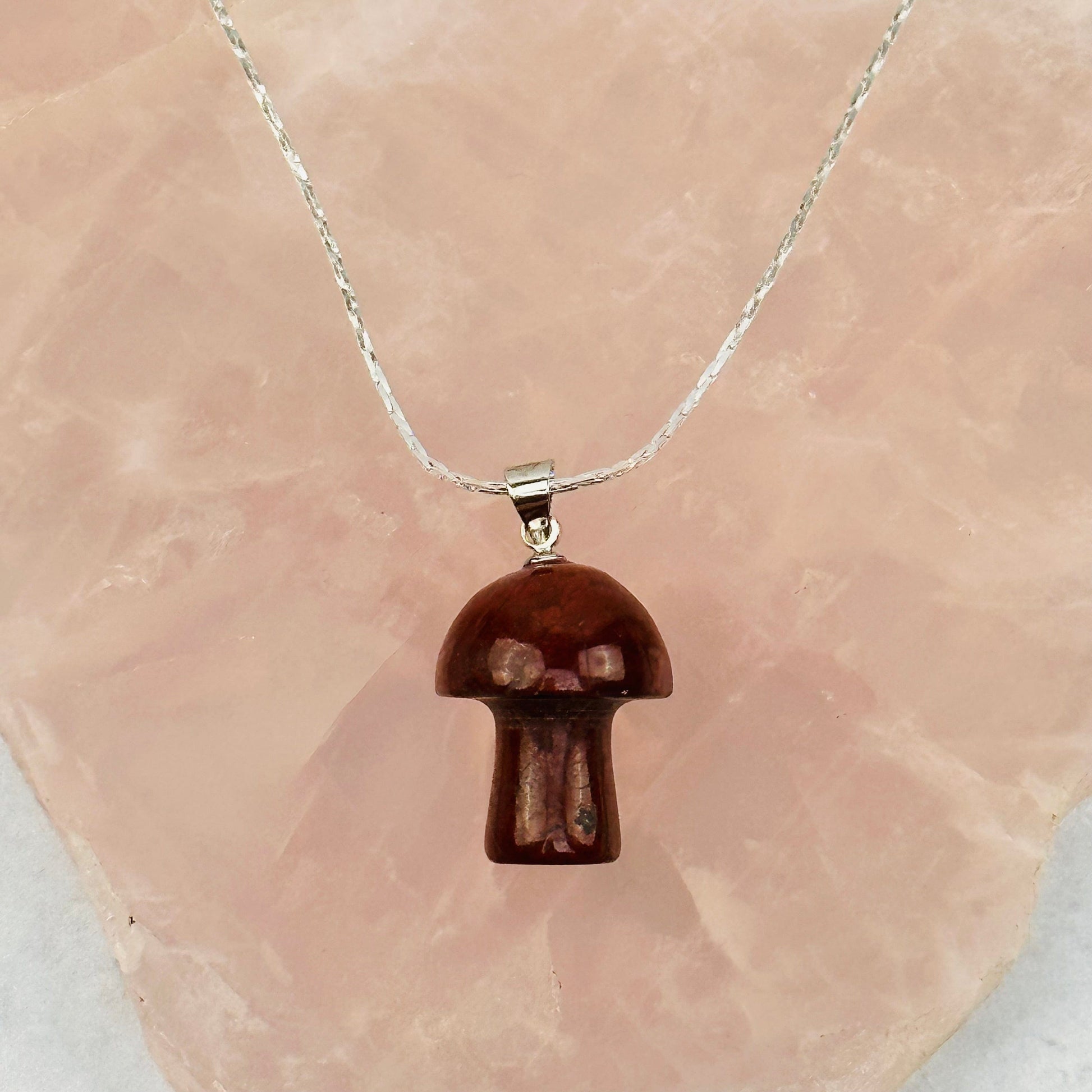 pendant displayed on a necklace wo show how it hangs