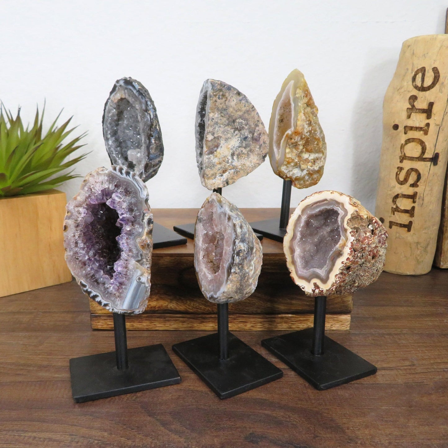 6 geodes on metal stands with decorations