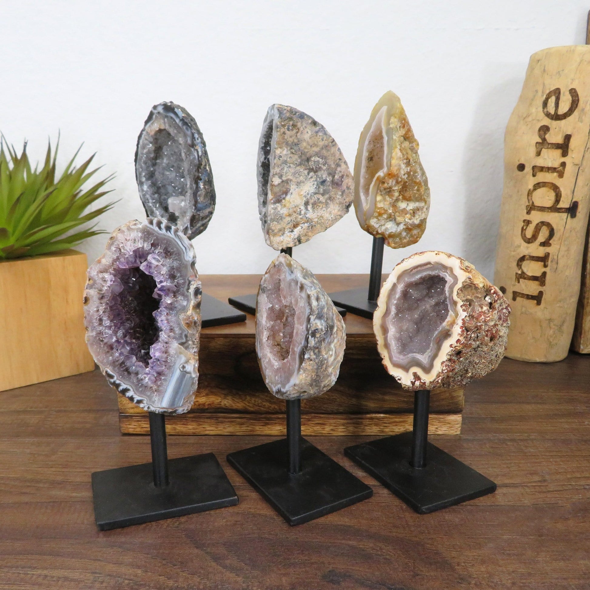 6 geodes on metal stands with decorations