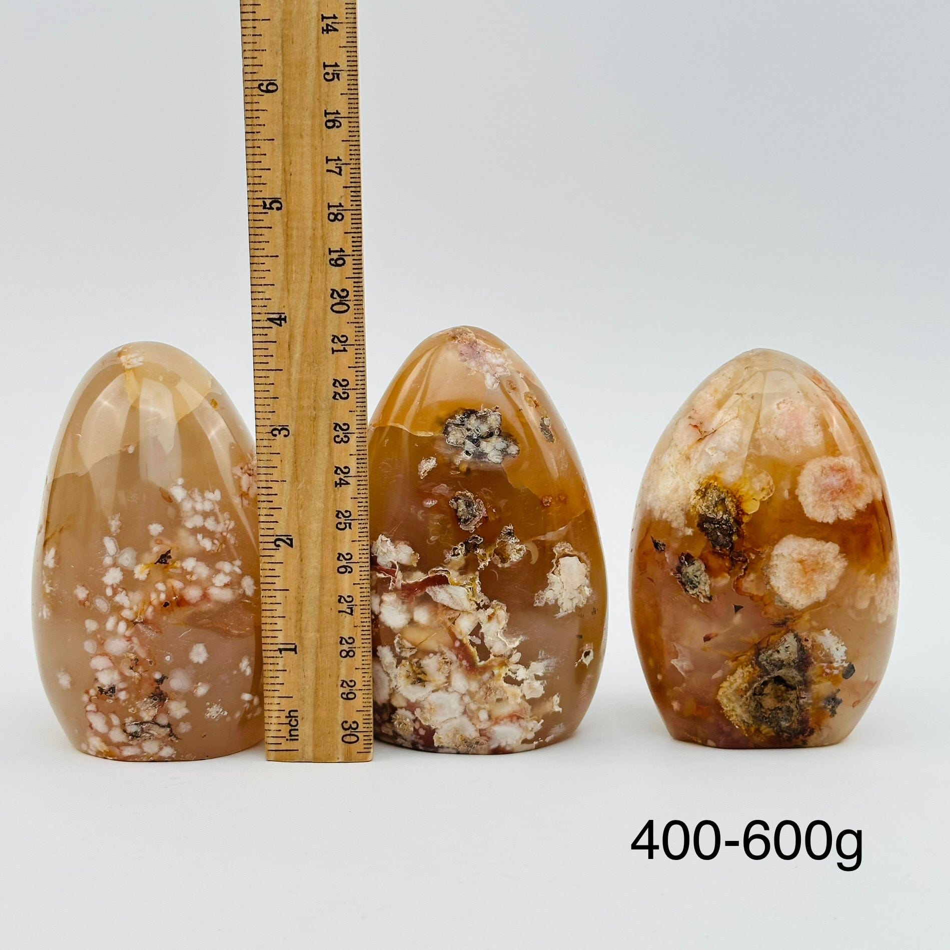 flower agate cut bases sold by weight. displayed next to a ruler for size reference 