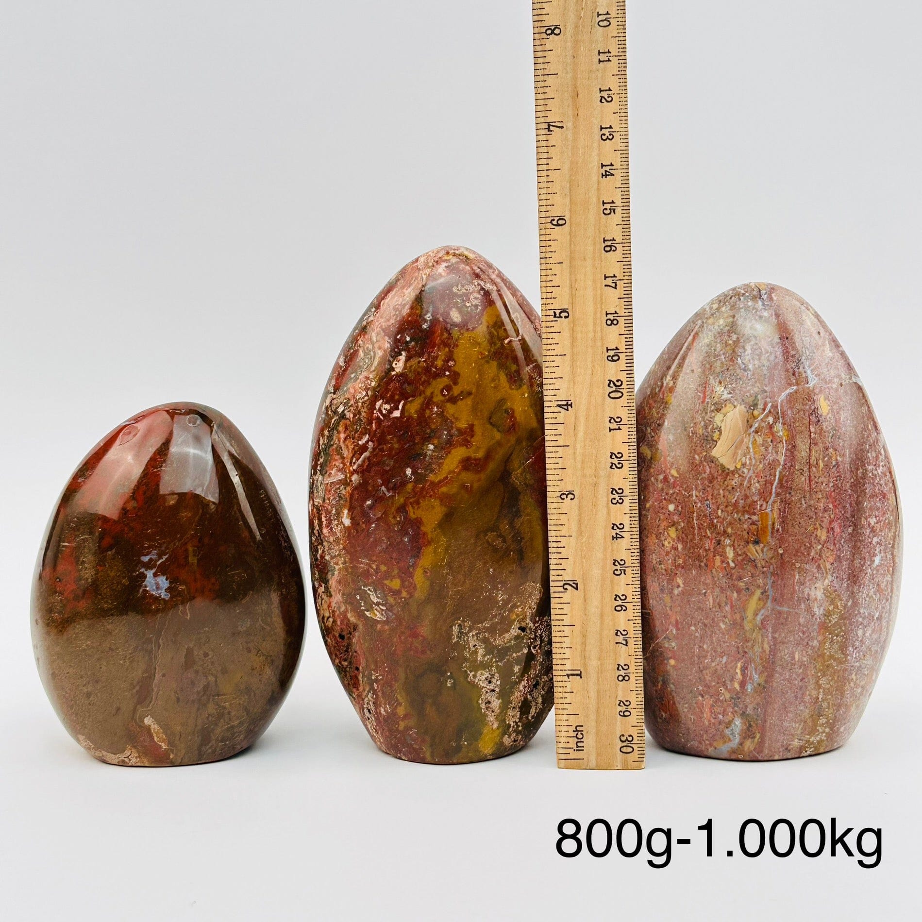 ocean jasper polished crystal cut bases sold by weight. displayed next to a ruler for size reference 