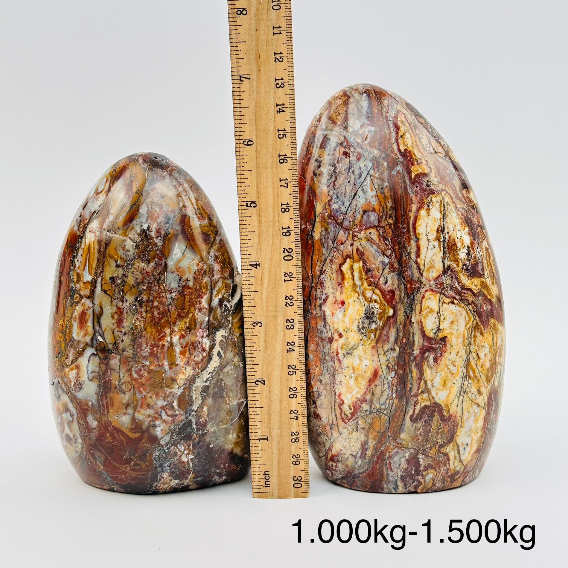 ocean jasper polished crystal cut bases sold by weight. displayed next to a ruler for size reference 